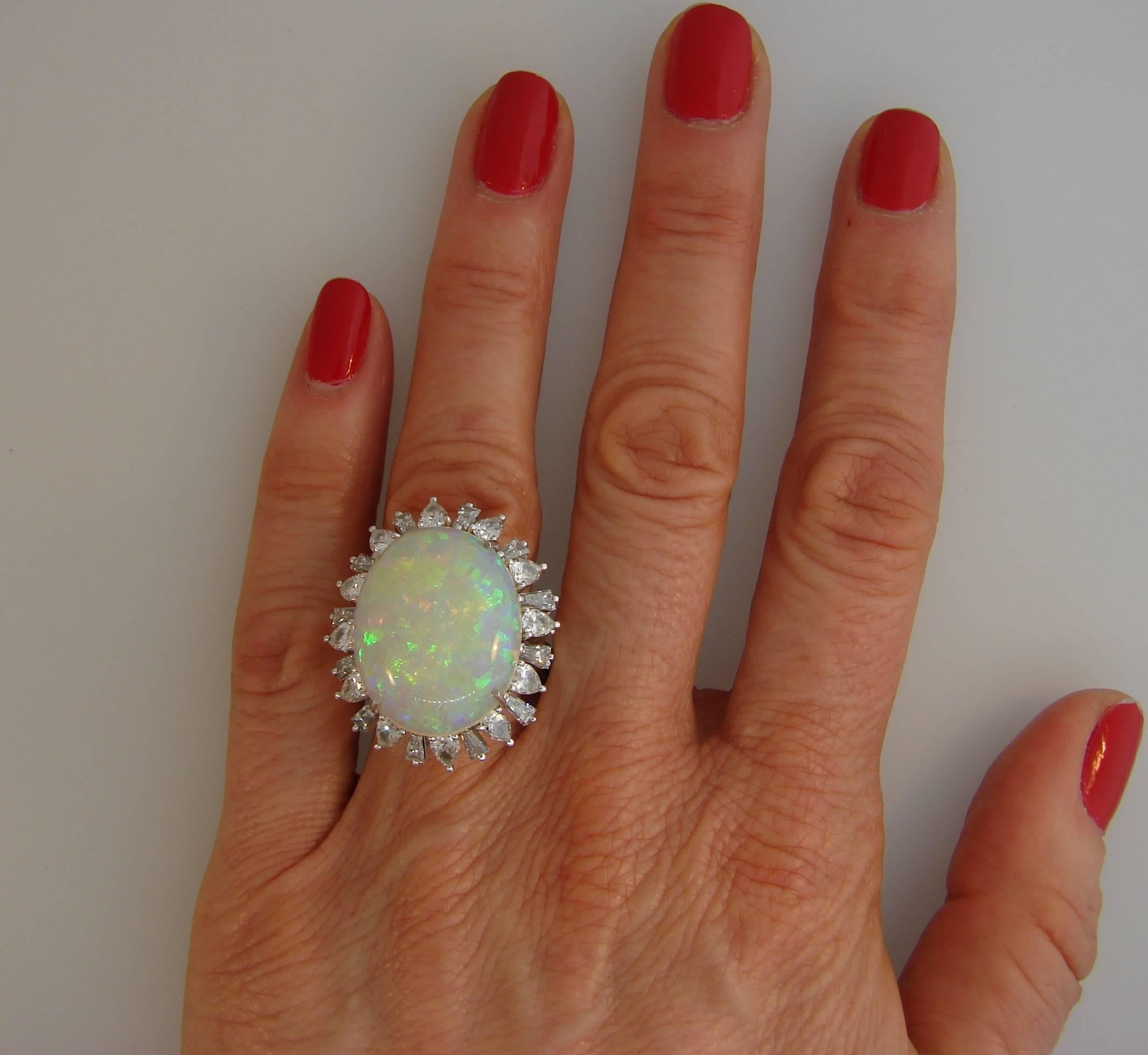 Stunning cocktail ring featuring an approximately 16-carat oval cabochon opal framed with diamonds and set in platinum. Bold and wearable ring that is a great addition to your jewelry collection.
Size 8; re-sizable.
The opal measures 22.92 x 18.18 x