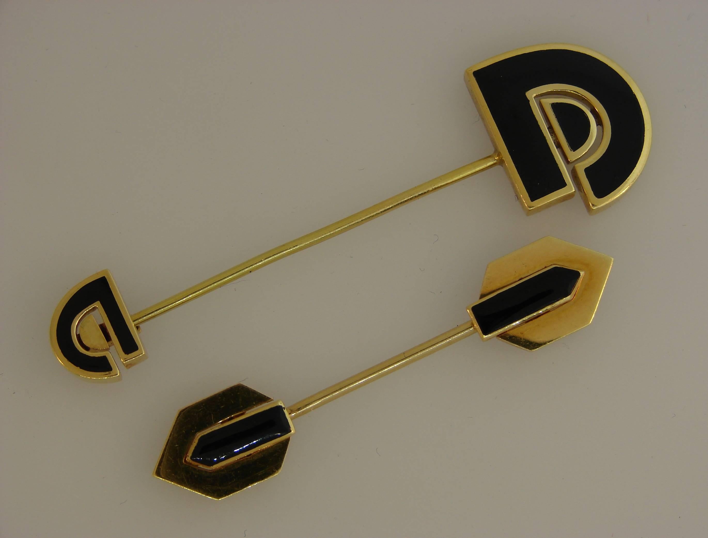 A pair of jabot pins created by David Webb in the 1980's. Elegant and stylish, the pins are a great addition to your accessories collection. 
Made of 18k (stamped) yellow gold and black enamel.
The larger pin measures 2-1/2 x 3/4 inch (6.8 x 2 cm)