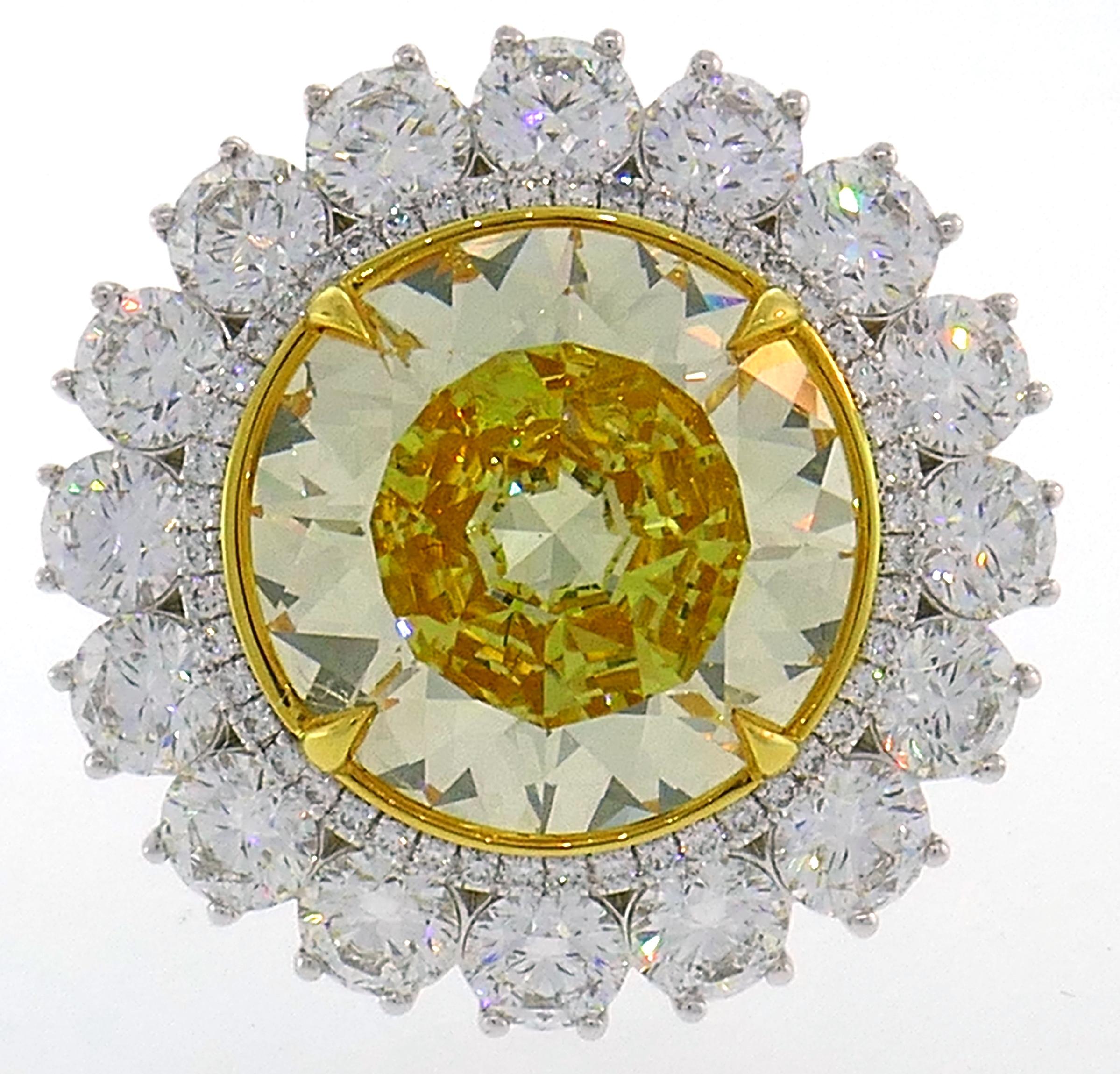 Magnificent fancy yellow diamond ring! Features a 10.04-carat natural fancy intense yellow round modified brilliant cut diamond framed by two rows of round brilliant cut white diamonds. The fancy yellow diamond comes with a GIA Colored Diamond