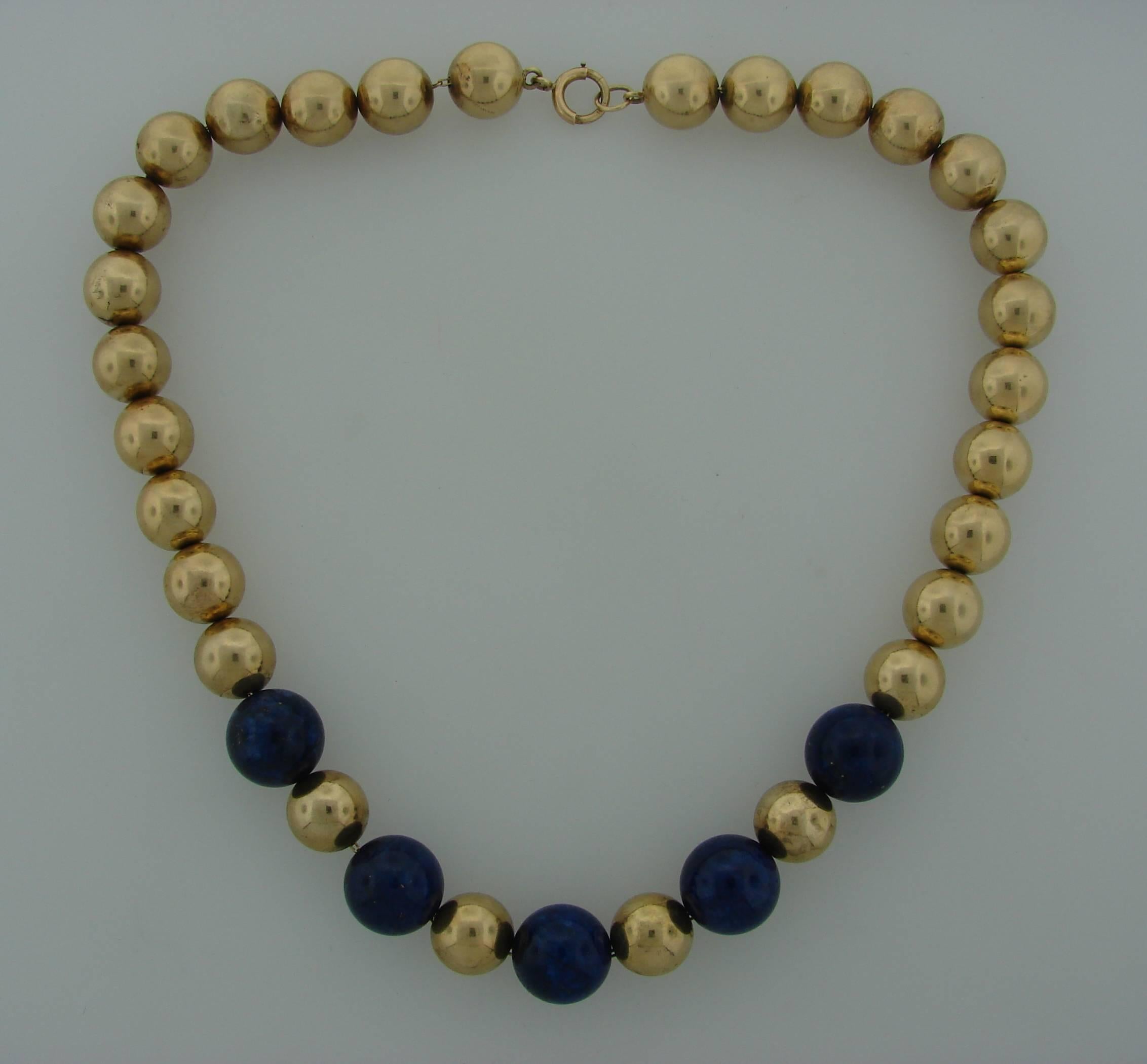 Lovely bead necklace created by Tiffany & Co. in the 1960's. Features five lapis lazuli beads alternating with yellow gold beads. 
The necklace is 18