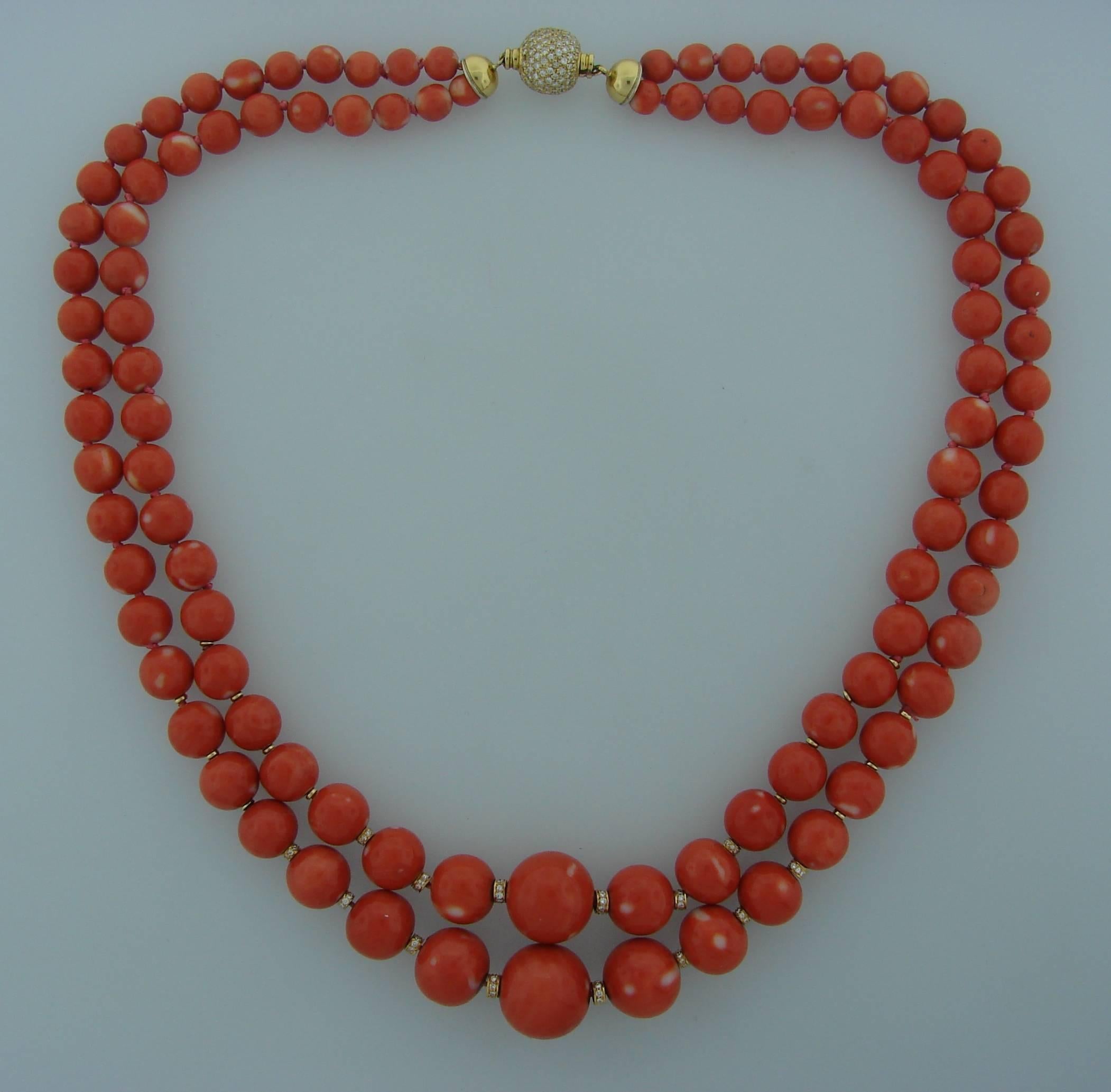 Beautiful two-strand Mediterranean coral bead necklace finished with a round diamond & 18k (stamped) yellow gold clasp and rondelles. The necklace made by Salavetti in Italy in the 1970's.The coral beads are graduating from 18 mm in diameter in the