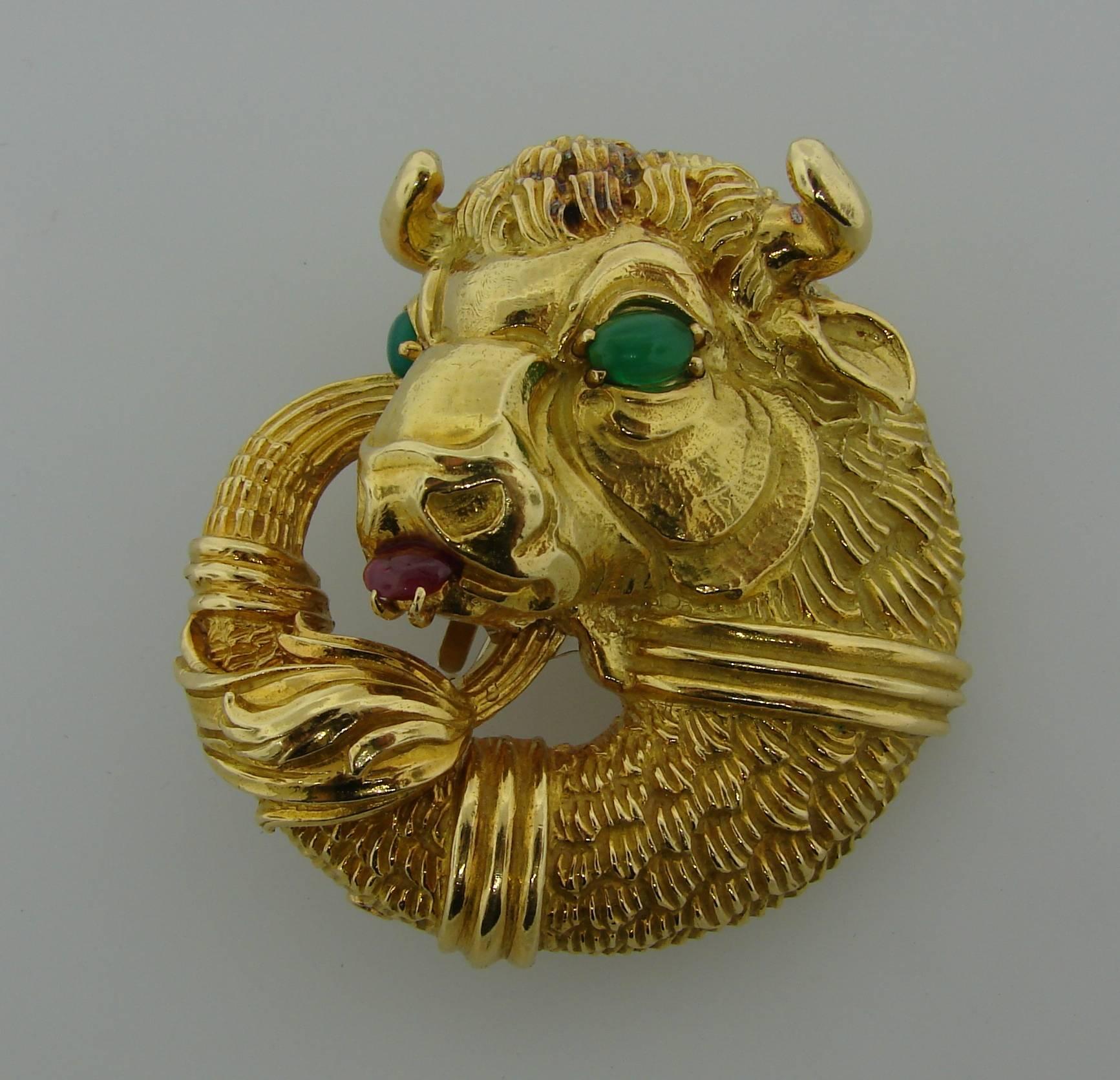Bold and colorful pin/pendant created by David Webb in the 1970's. David Webb got a lot of inspiration in the Animals World and this bison pin is a great example of it. 
Made of 18 karat (stamped) yellow gold, the bison's eyes are accented with two