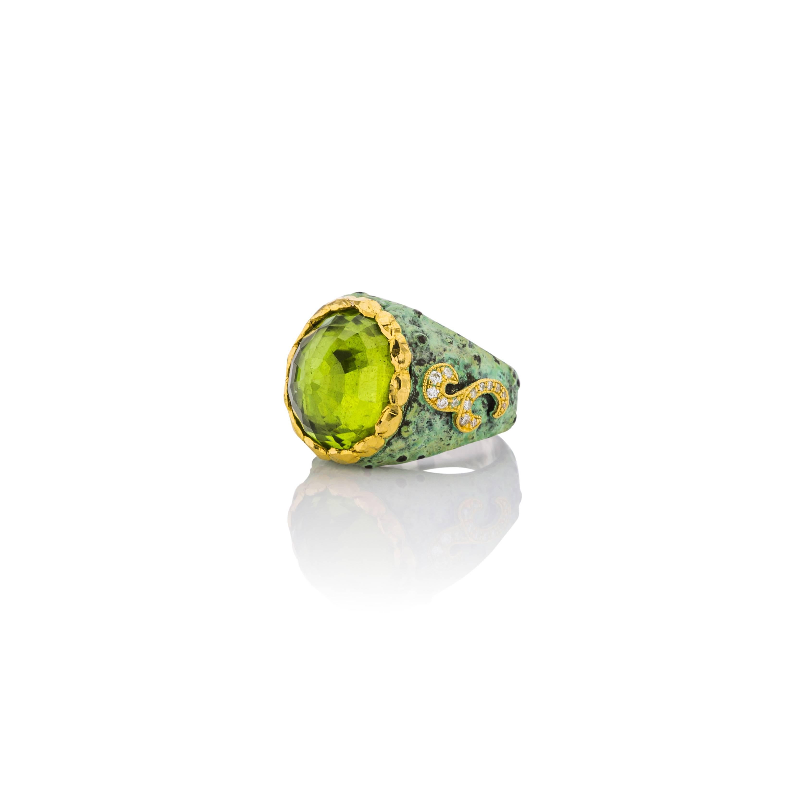 This ring by Victor Velyan has a 14ct. Peridot with 28 Diamonds that equal .21cts.  24K Gold Accents on Sterling Silver complete this look.   
This ring features Victor's classic patina work in green.  Truly a work of art, the Gold on the sides of