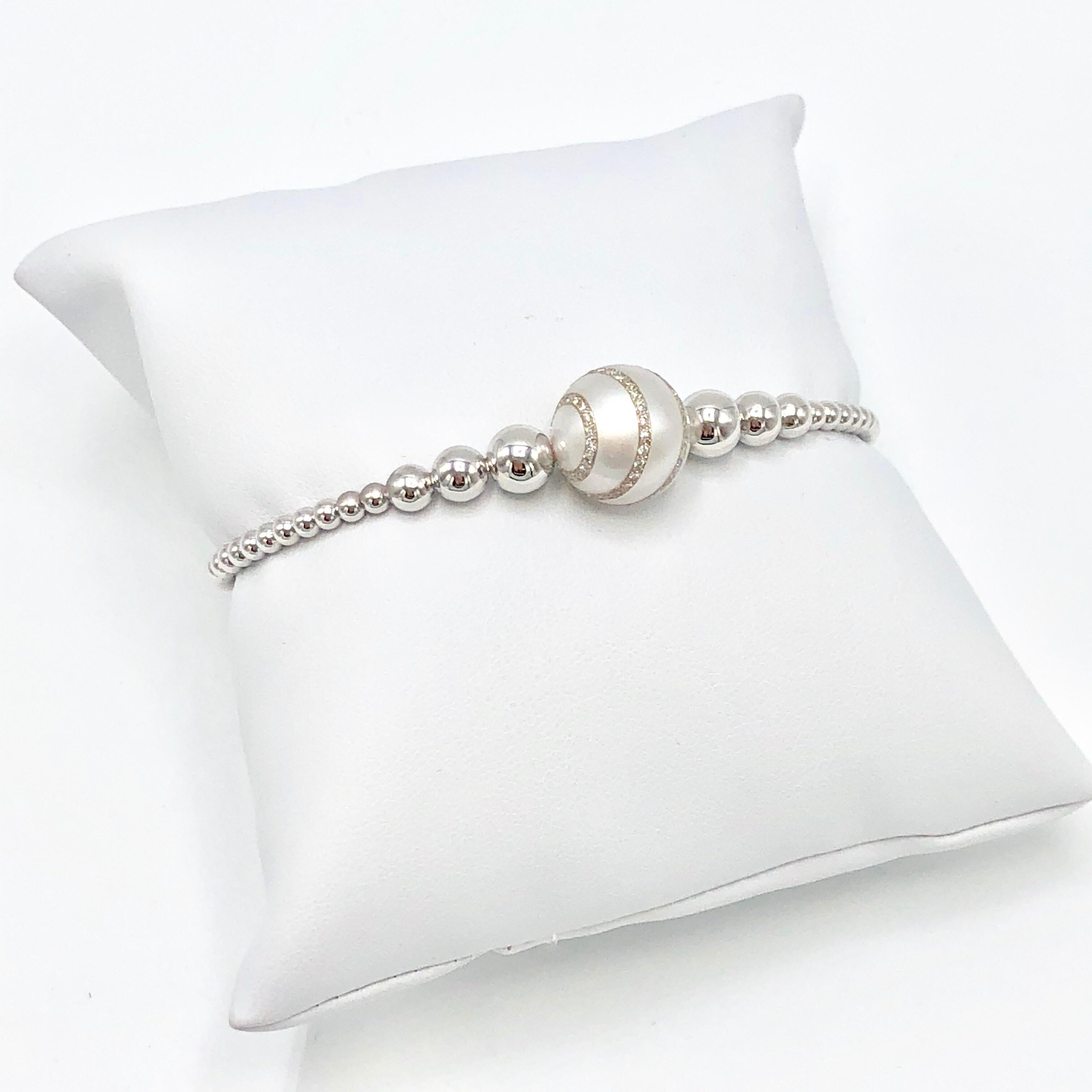 18K White Gold South Sea Pearl and Diamond Bangle designed with .28 Carat Weight Diamonds set in the Pearl.  Flexible Bangle which separates at the back to comfortably place on wrist and remove. Magnet clasp. New, never worn.   
Made in Italy