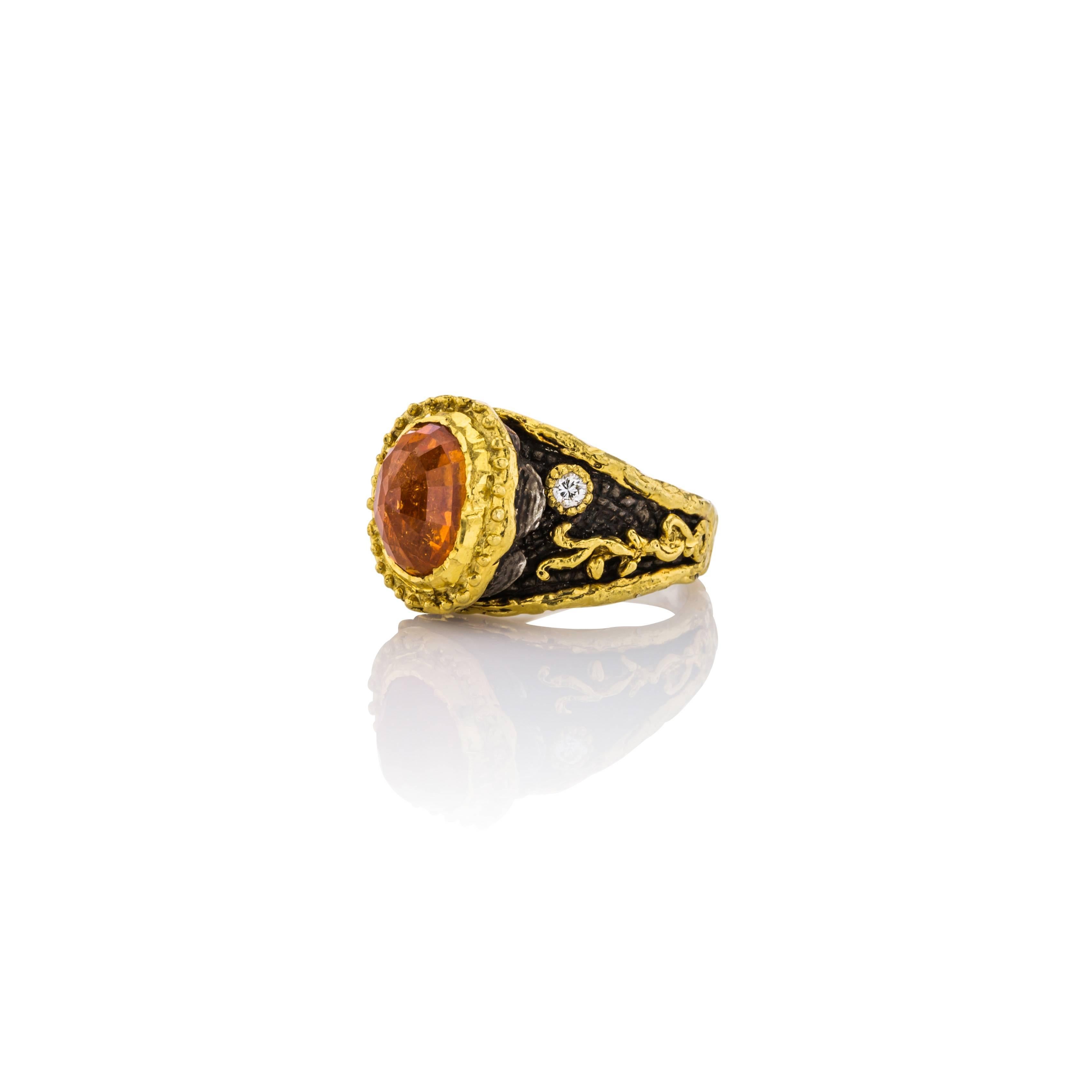 Beautiful ring designed and made by Victor Velyan.  This ring can be custom fitted to your finger size.  This Sterling Silver Ring with 24K Gold and diamond accents has a center stone of Spesertite Garnet and a brown patina background which is