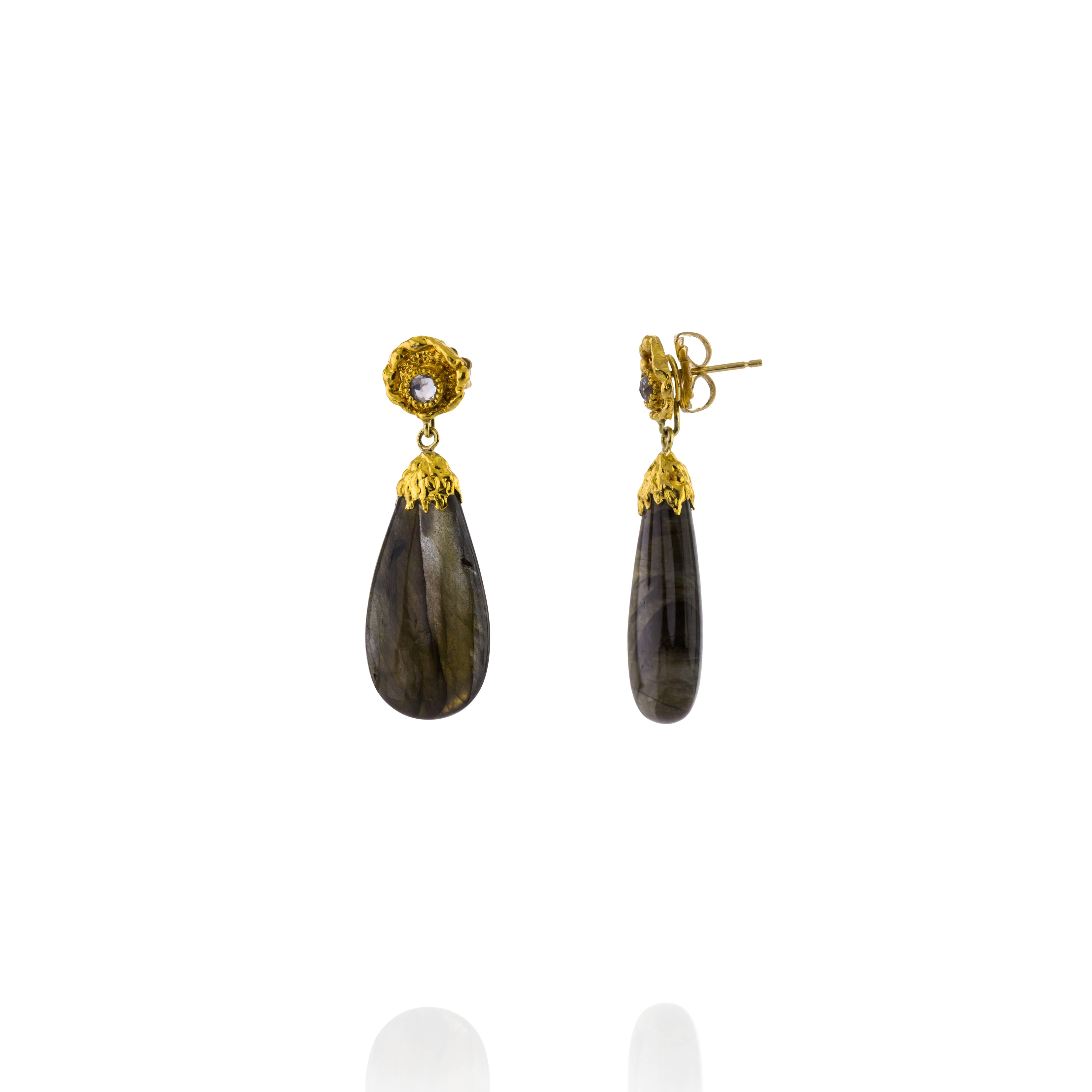 Earrings designed and made in the USA by inspired designer Victor Velyan.  The earrings are made of a base of Sterling Silver, with 24K Gold Accents.  54.62 CT Labradorite Drops complete the look. The tops also have White Zircon Stones.  