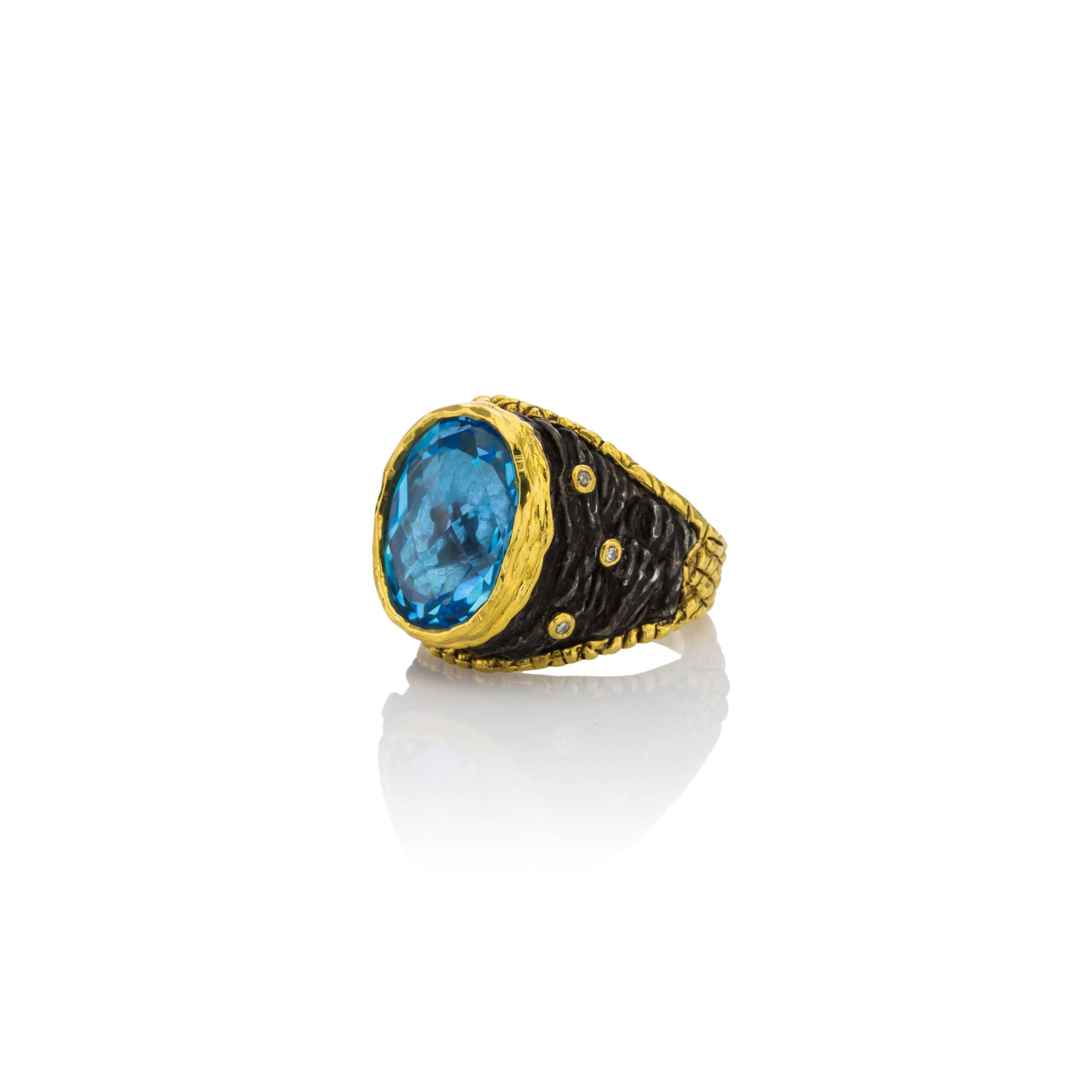 Enchanting Ring from Designer Victor Velyan.  This ring has a faceted 13CT Blue Topaz center stone with .06cts Diamonds.  24K heavy gold over Sterling Silver. Brown patina which is proprietary to Victor Velyan is hand painted and bonded with the