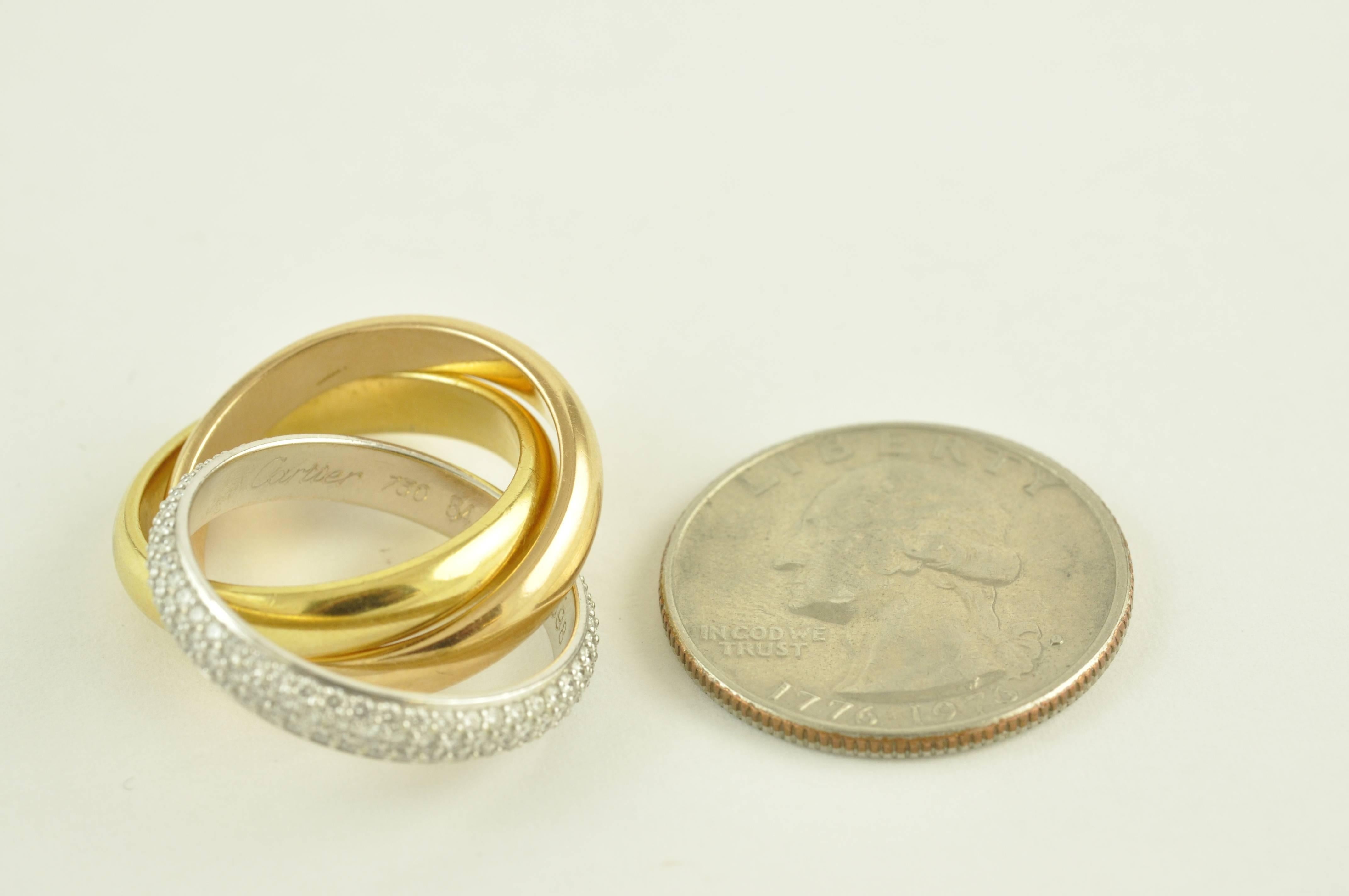Three Metal Cartier Rolling Ring with Diamonds

Width on Bands 4mm.  Combination of Rose, Yellow and White Gold. White Diamond Band has three rows of Diamonds.  Cartier Style number OC7O98.

Stamped 750 Cartier.  As new.  Diamonds are F VVS/1.

Size