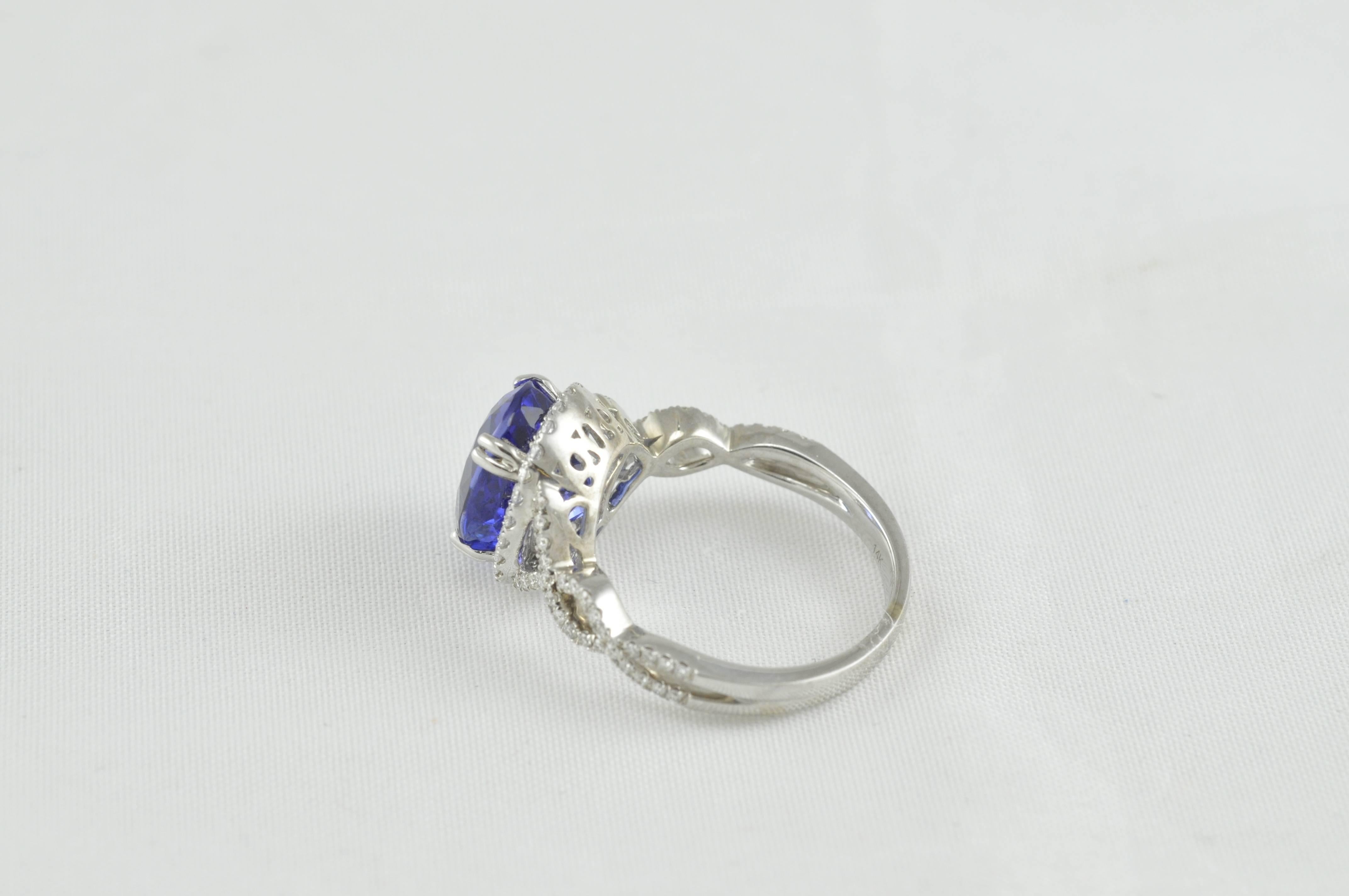 Beautiful Uneek Tanzantite Ring.  Finger Size:  6.5 but can be sized to fit.  14K White Gold with .50 CTW Diamonds.  5.32 Carat Oval Tanzanite.  81 Diamonds are GV/S1.  8 prong setting.  Intense, Purplish Blue Color. 