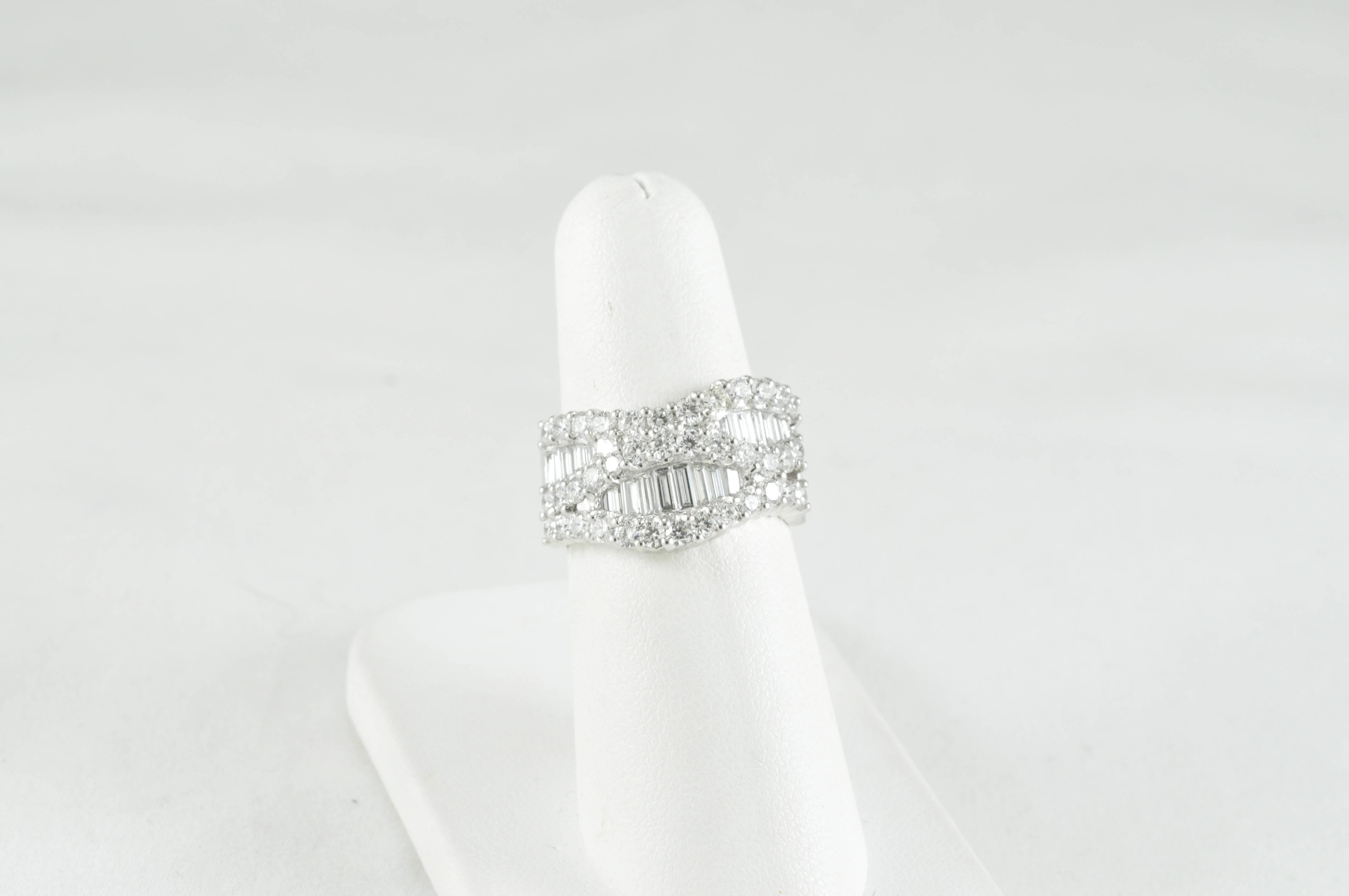 18K White Gold and Palladium.
Finger Size 6 3/4, can be sized. 
1.43 CTW Round Diamonds
.69 CTW Baguettes
Made by Award Winning Designer Jye's.  Very comfortable beautiful ring. 
Diamonds are F-G Color V/S1 Clarity. 