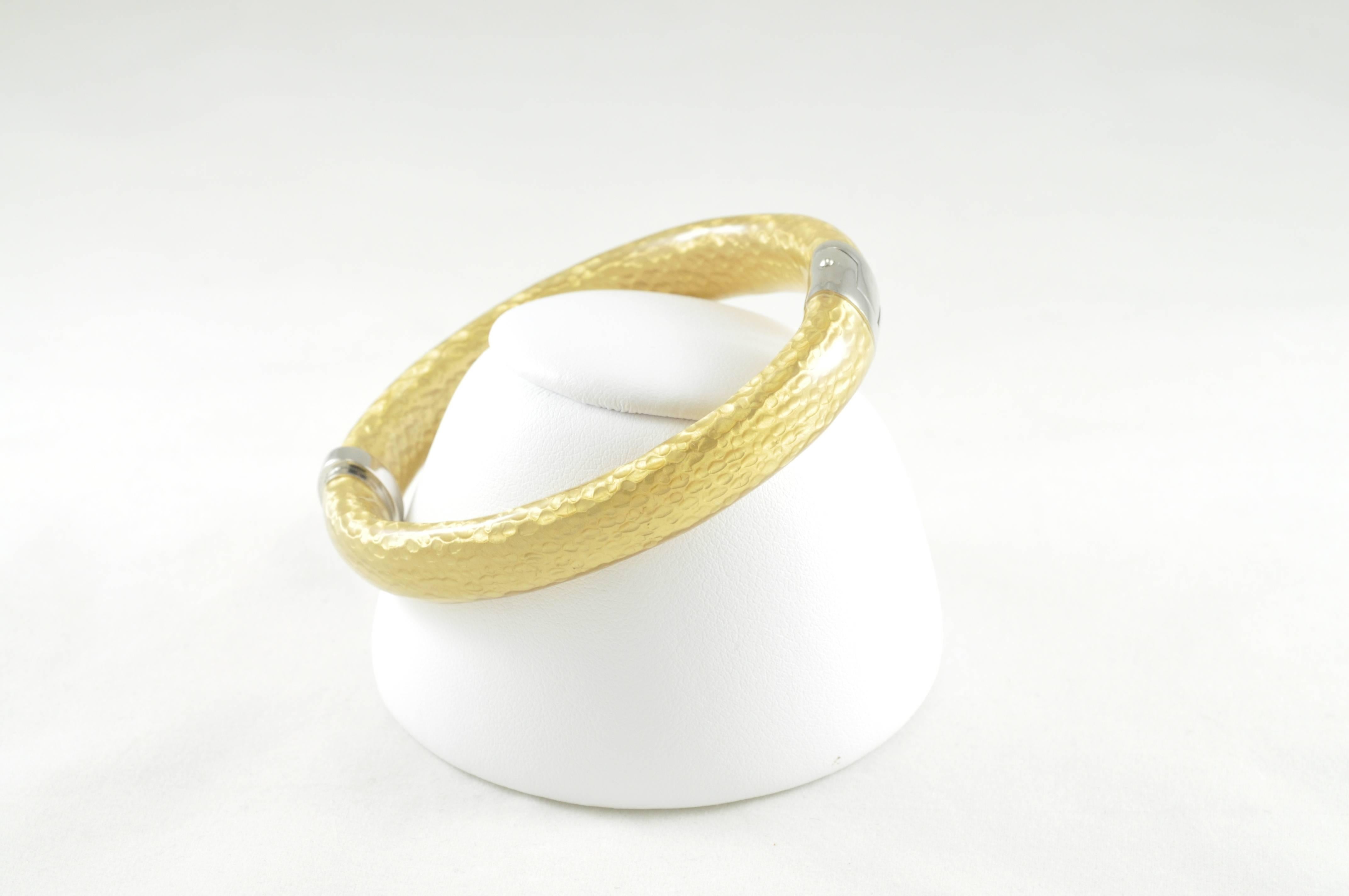 Beautiful SOHO designed Sterling Silver and Hammered-look Gold Enamel clamp bracelet with a Smooth finish. Interior dimension of 6.5 inches. Bracelet is stamped SOHO SLVR Ag925 Italy.
This bracelet looks wonderful alone or in groups for a fun way