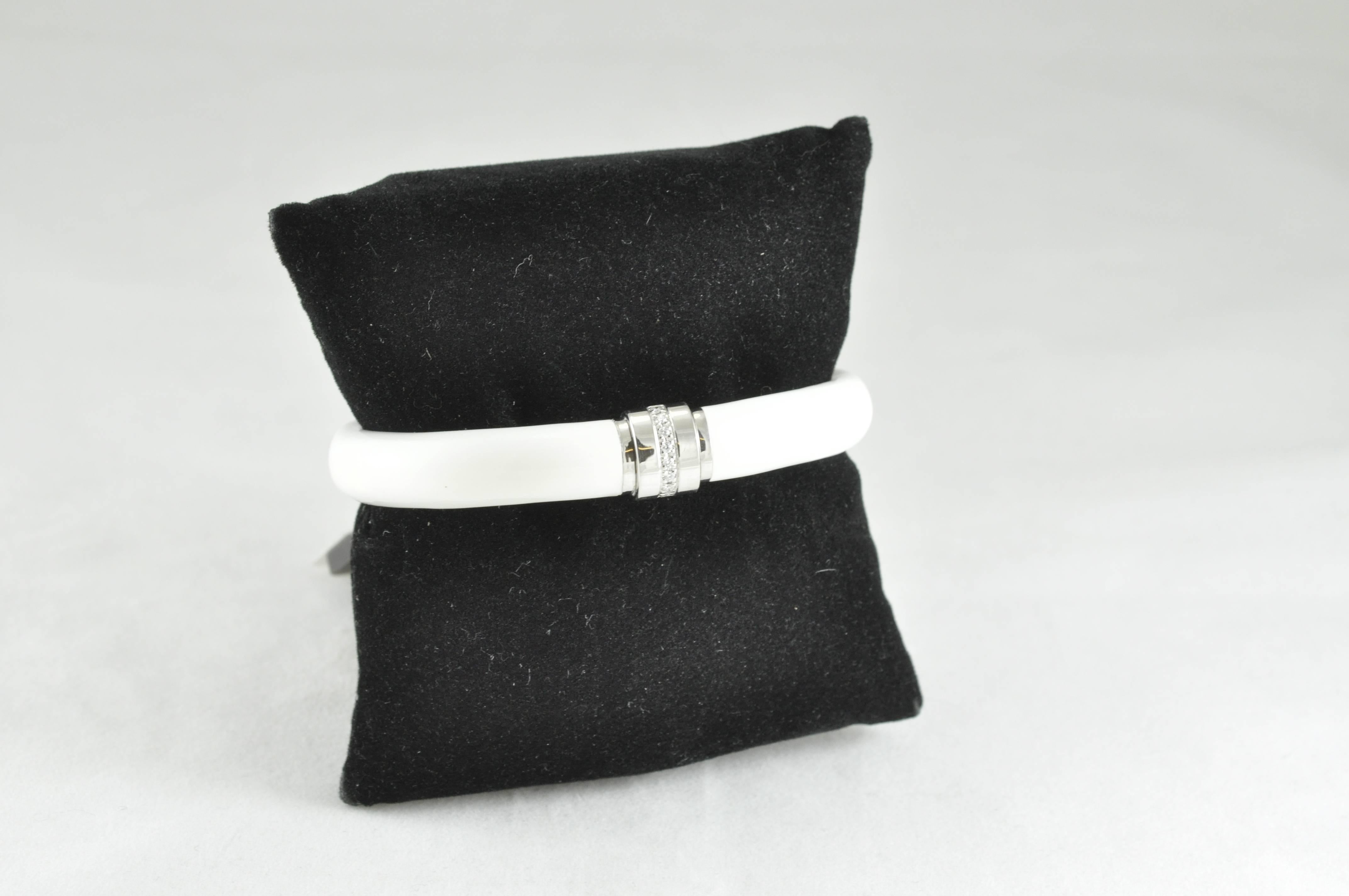 Designed by SOHO, this beautiful bracelet is made of Sterling silver, White enamel with 0.12ct of Diamonds. The bracelet is 9.5mm thick and looks lovely worn alone, or stacked with complimentary pieces. The bracelet is stamped SOHO as well as ITALY