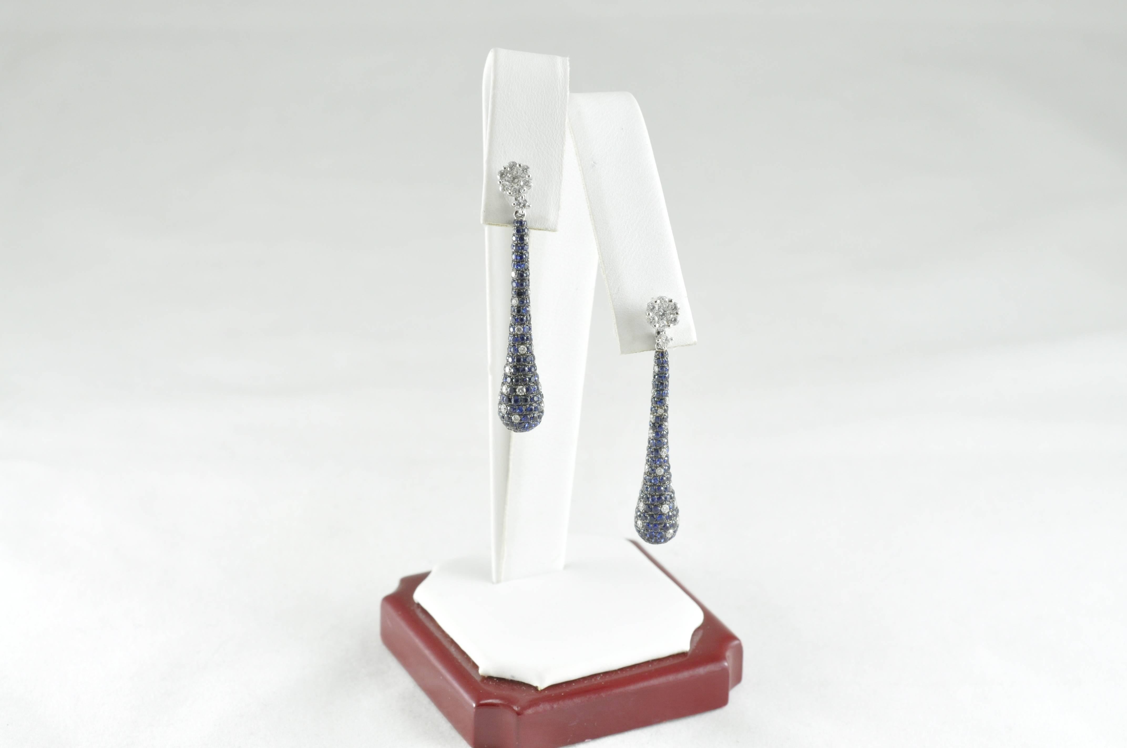 18k White Gold Drop Earrings with 3.58ctw Sapphires and 1.19ctw Diamonds. Sapphires and diamonds are intermingled to give you the effect of a rain shower. 

