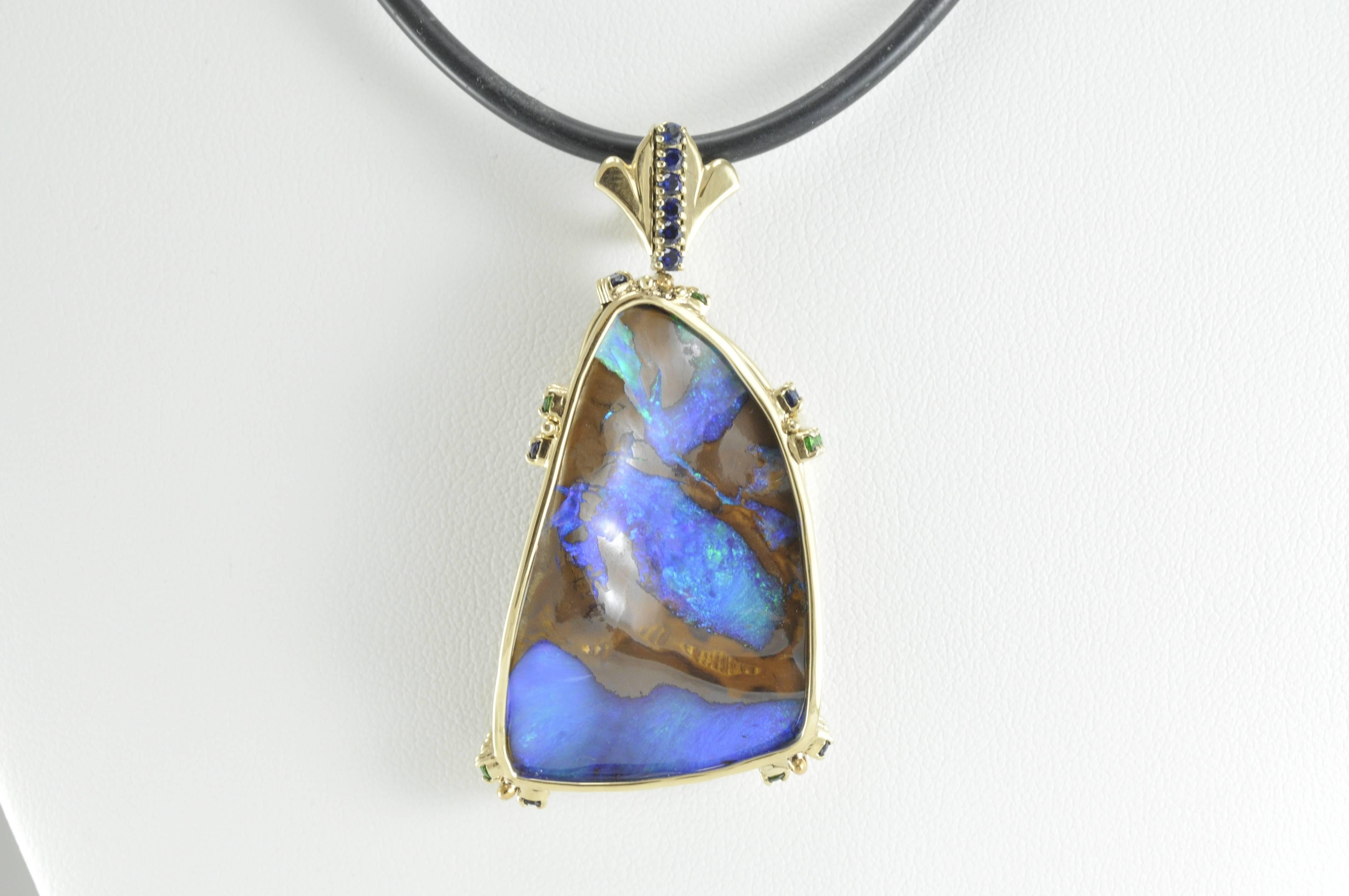 Charles Skibell Custom designed 62.5ct Boulder Opal in 18ct yellow gold with Tsavorites and Blue Sapphires on Black Silicone 16" cord.