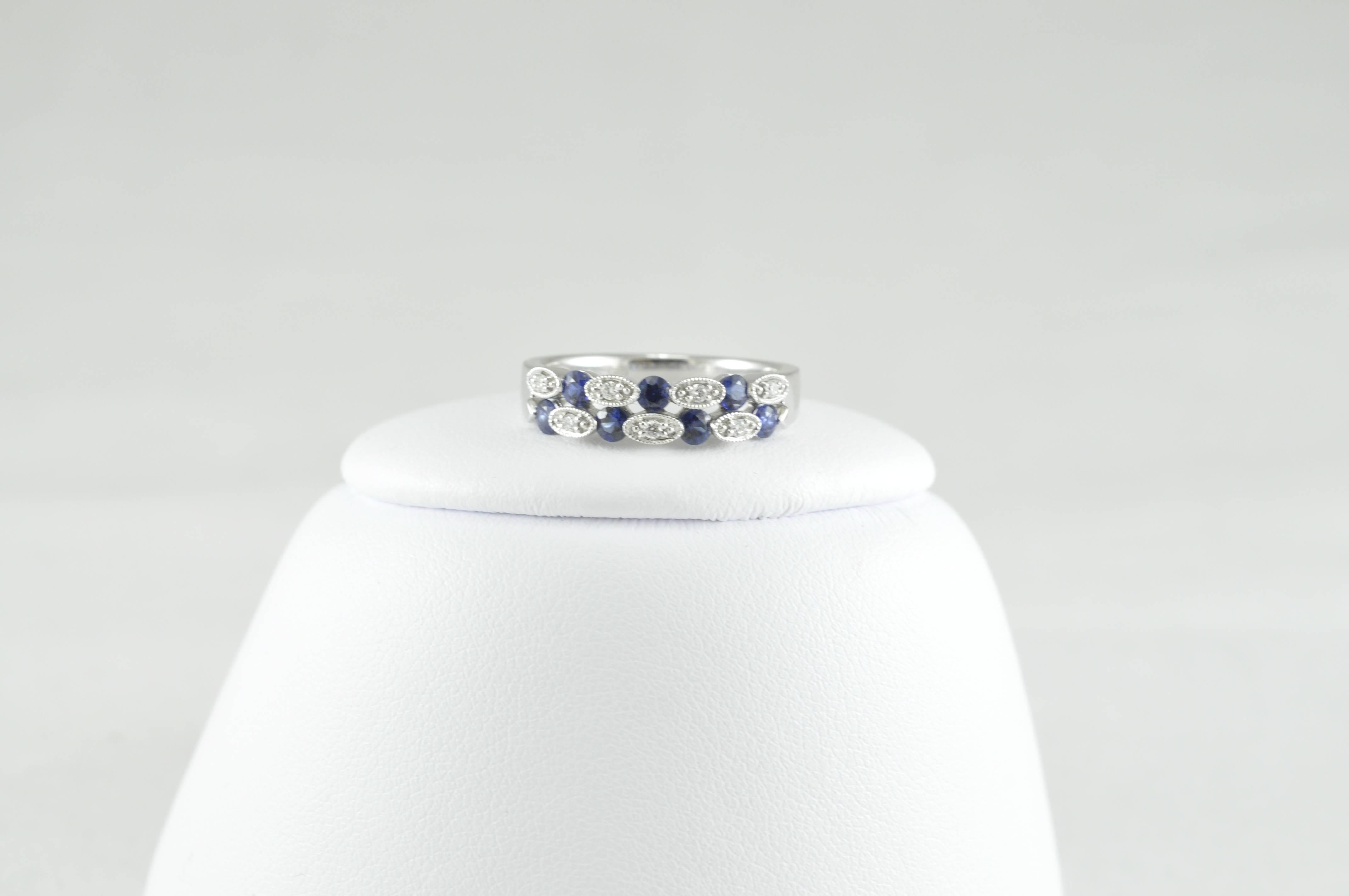 This gorgeous ring is from Jewels by Jacob.  Sized 6.5 and can be sized.  
18kw Band with Diamonds and Sapphires on the front.  .06CT Diamonds and .54CT Sapphires.  Very pretty dainty band, extremely well made. 