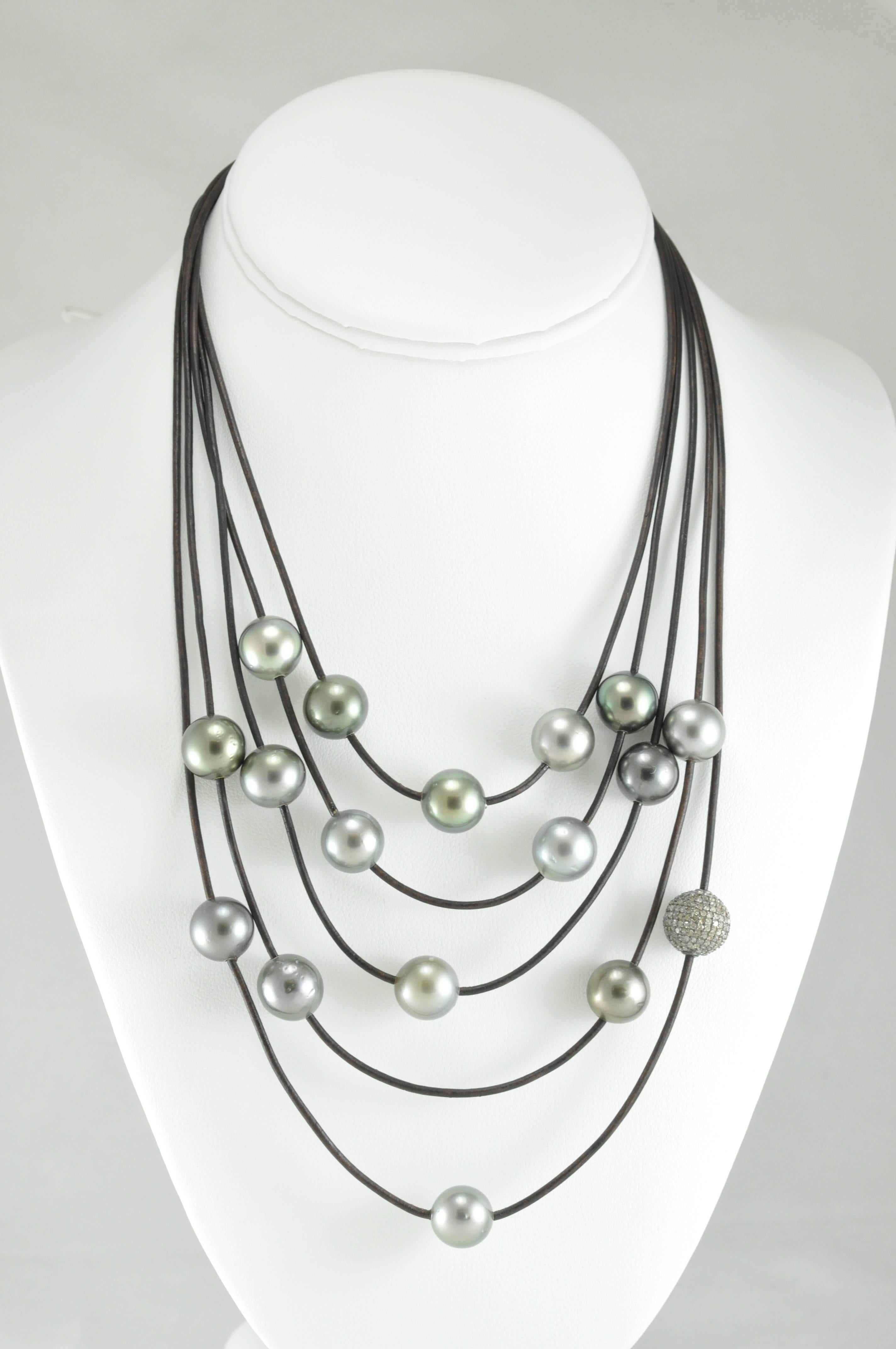 Beautiful 5-strand Tahitian pearl and Leather necklace, one strand with diamond pave pod. This necklace is beautiful when dressed up or down and feels comfortable when worn either way. Fits in at a barbeque, or a lovely dinner out.
Shortest strand