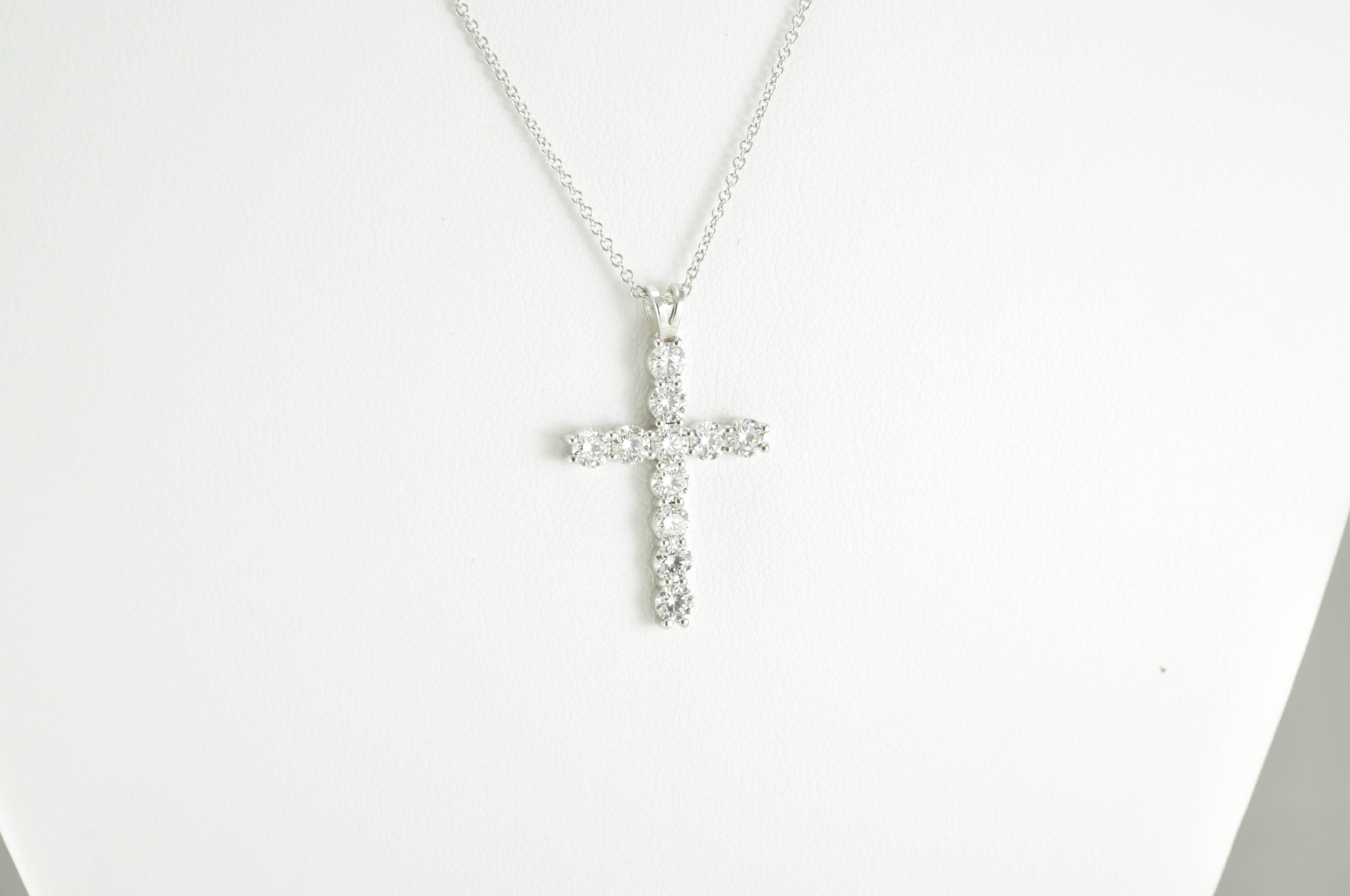 14k White Gold Diamond Cross consisting of 1.97ct in 11 round brilliant cut stones measuring 3.5 mm each.
The cross itself measures 1.13 inch tall, 0.75 inches wide and 0.13 inches deep. The chain itself measures 16 inches long.