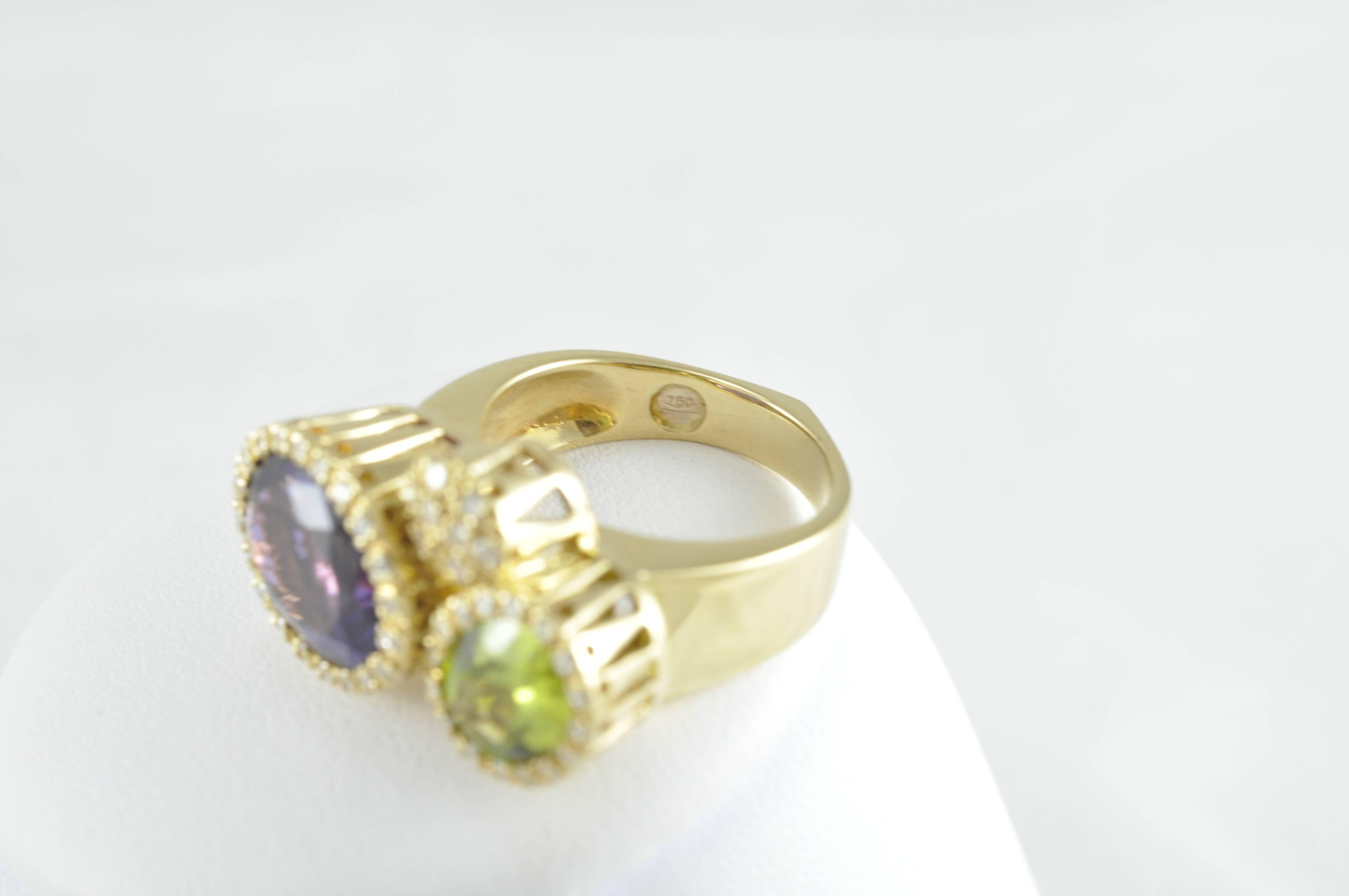 18k Ring featuring oval Amethyst and oval Peridot surrounded by Round Diamonds, with a third round section of Round Diamonds. The ring is stamped 750 also has initials MM and PVG on under gallery for designer Ponte Vecchio Gioielli.
The ring is