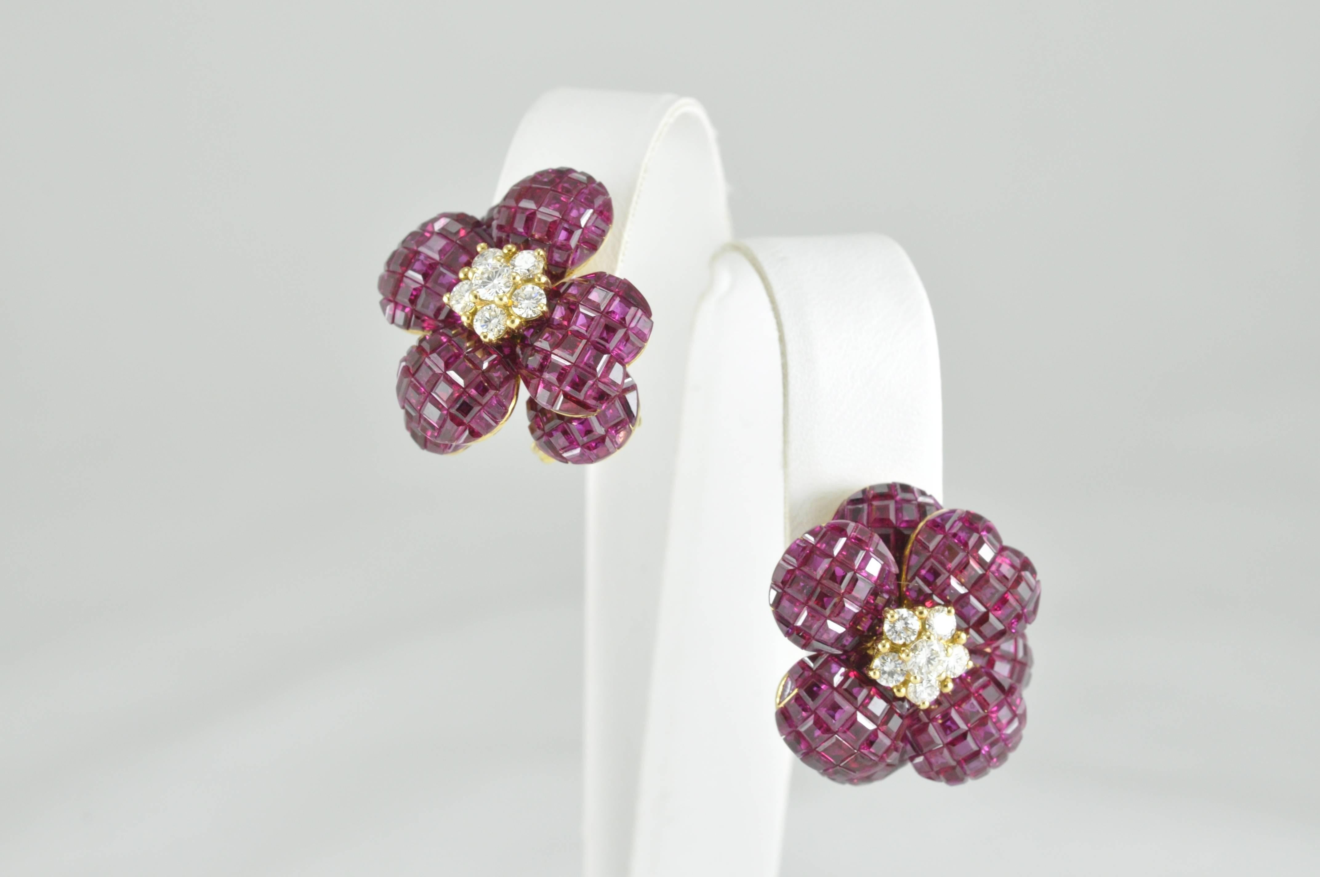 18k Yellow Gold Flower Earrings featuring 8.0ctw Rubies and 0.6ctw Diamonds invisibly set to form these beautiful, delicate looking earrings. These earrings also have the feature of a folding post, so they can be worn as post or clip