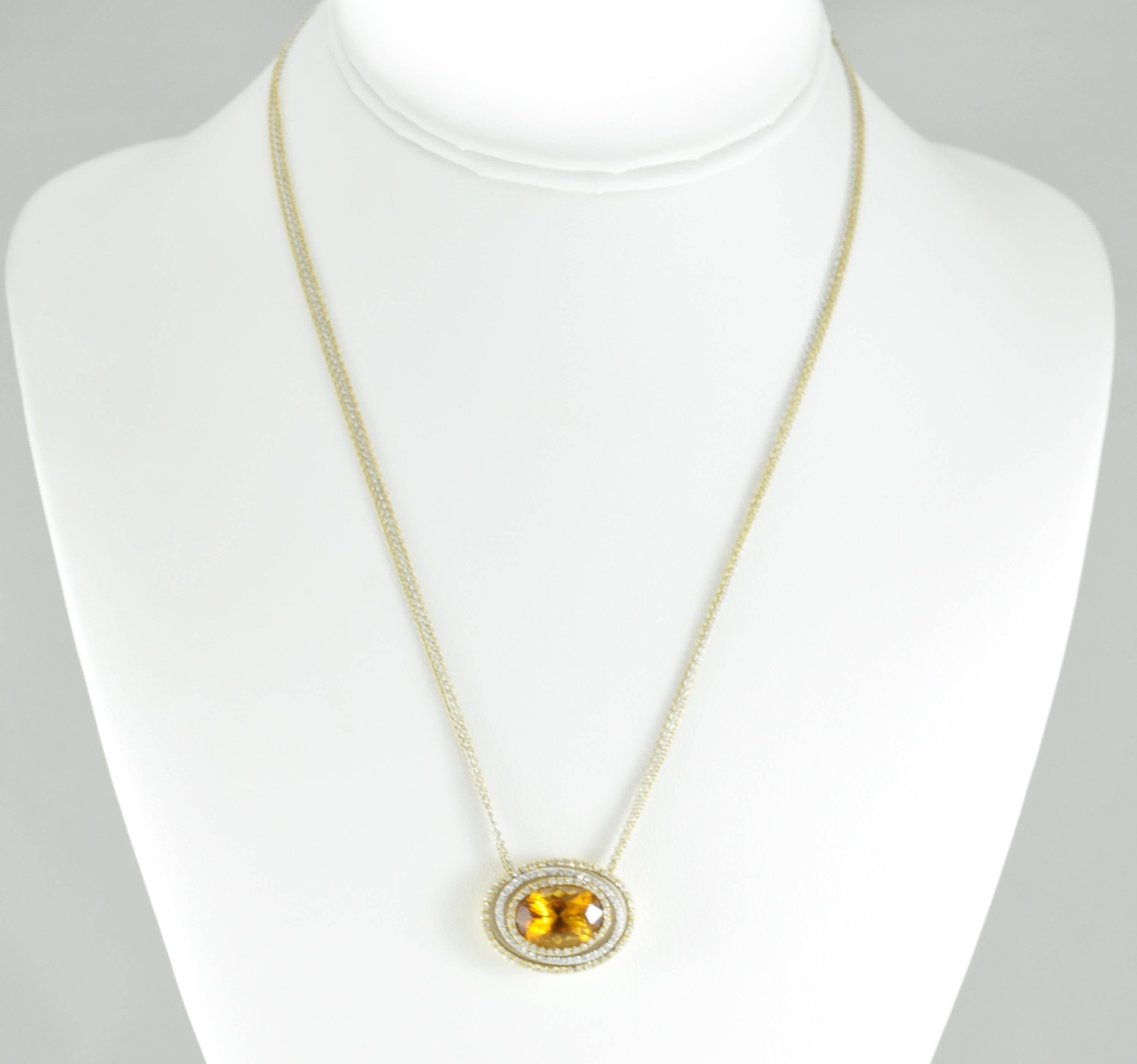 18k Yellow Gold Citrine Oval Pendant with 3 Rows of Diamonds on Triple Chain. The Chain consists of two Yellow strands and one White Gold strand. This piece also has a beautiful toggle clasp with 6 round diamonds on the toggle bar.
The necklace has