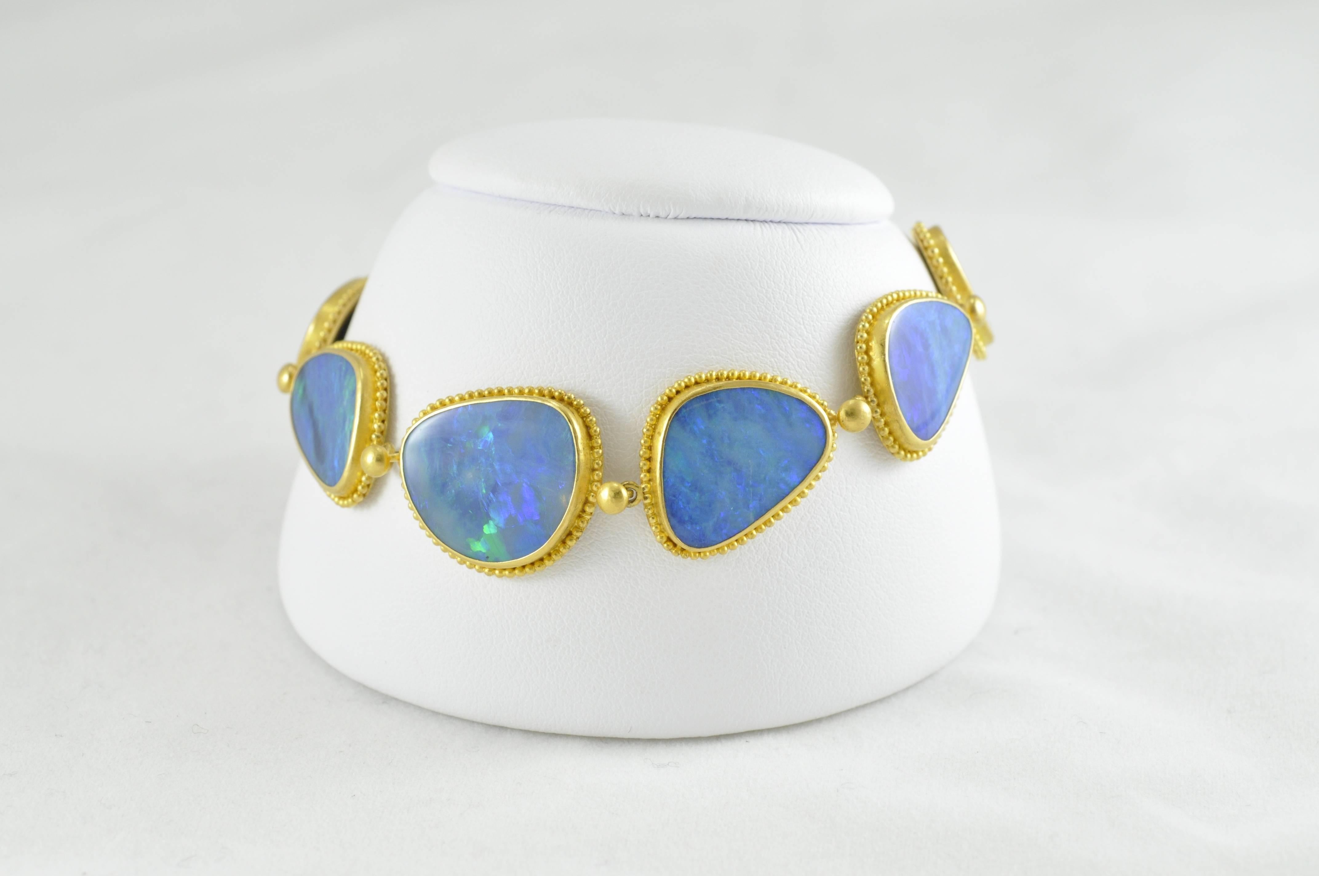 Carolyn Tyler-designed, 22k Gold 46ct Blue Australian Opal Natural Ironstone Doublet bracelet. The piece is stamped 22k, C TYLER and INDONESIA.