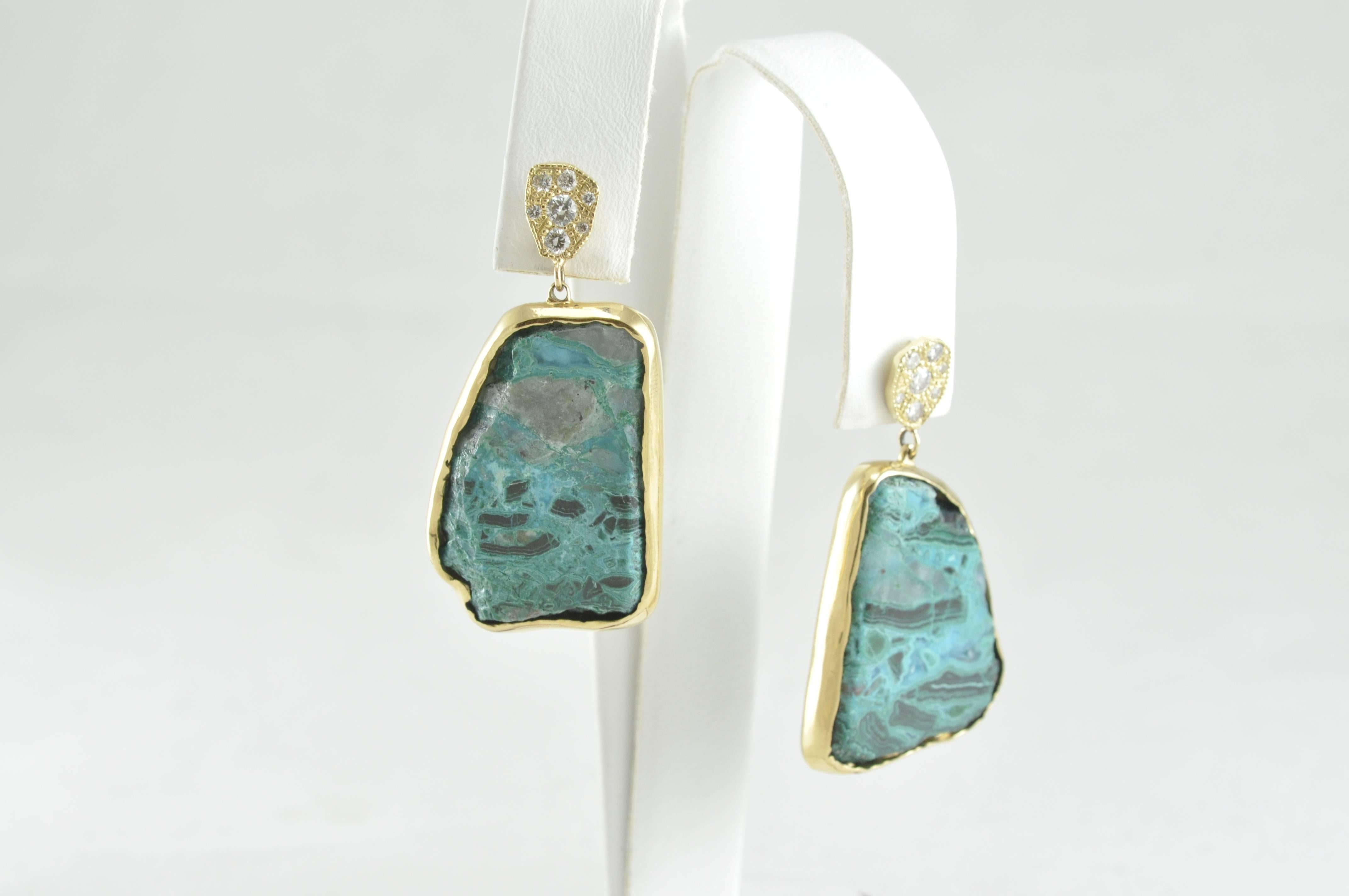 One of a Kind! The asymmetrical shape of the bright blue stones adds to the appeal and intrigue of these phenomenal hand made earrings. 

18K Yellow Gold, Chrysocolla and Diamond Earrings from hot new designer: Rocky Gem Designs. This amazing set of