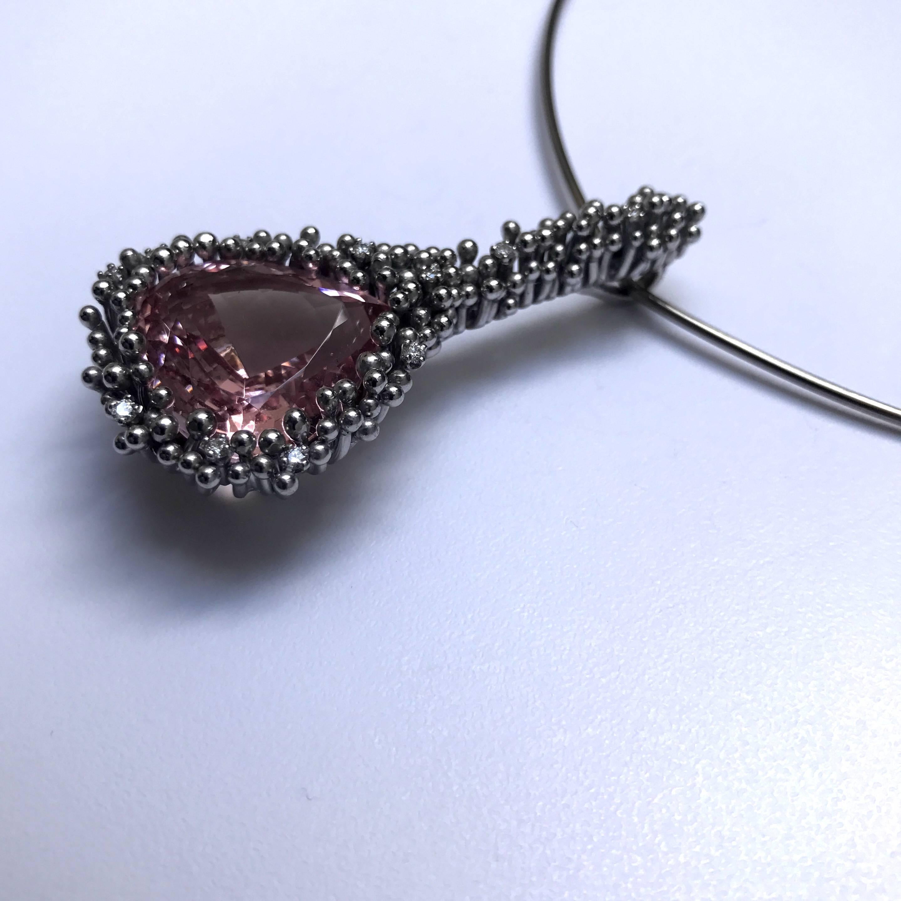 Designed by Andrew Grima in 2005, made by Grima in 2008 
A large drop-shaped Morganite weighing 33.25cts set with white gold "stems", eleven of which feature brilliant cut diamonds.  On a V-shaped white gold torque.  Pendant and torque
