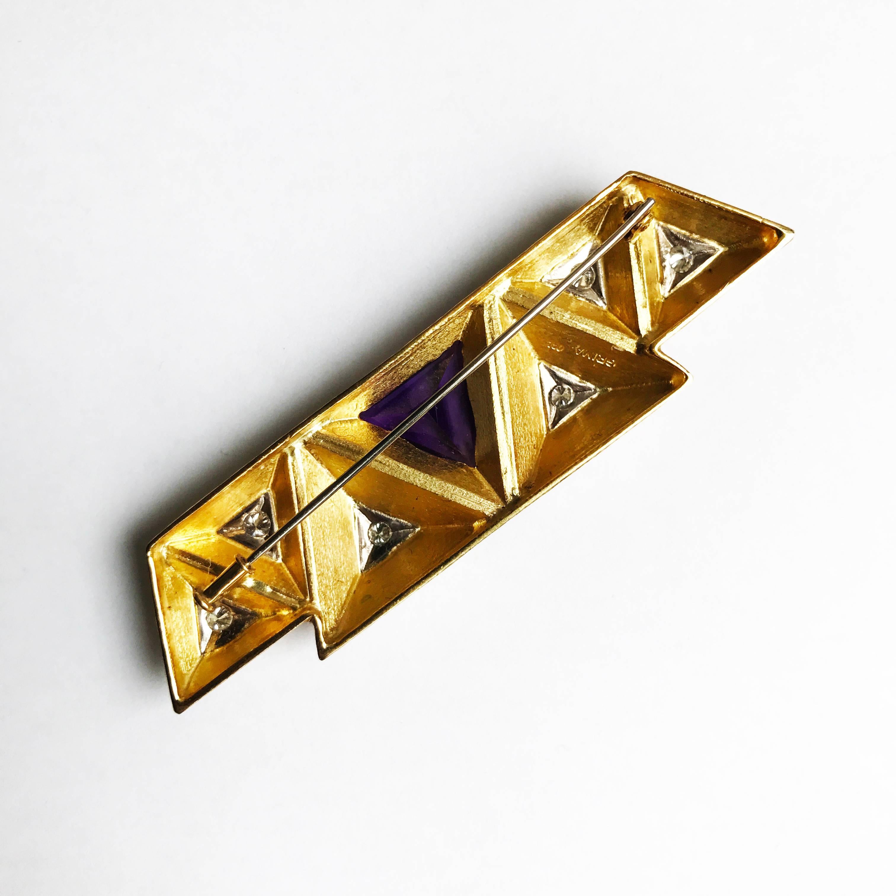 Designed by Andrew Grima in 2002

A yellow gold brooch set with 6 brilliant-cut diamonds in white gold and a triangular amethyst weighing 6.09cts. 

Signed GRIMA, 750

About Grima
Andrew Grima was one of a handful of British designers who