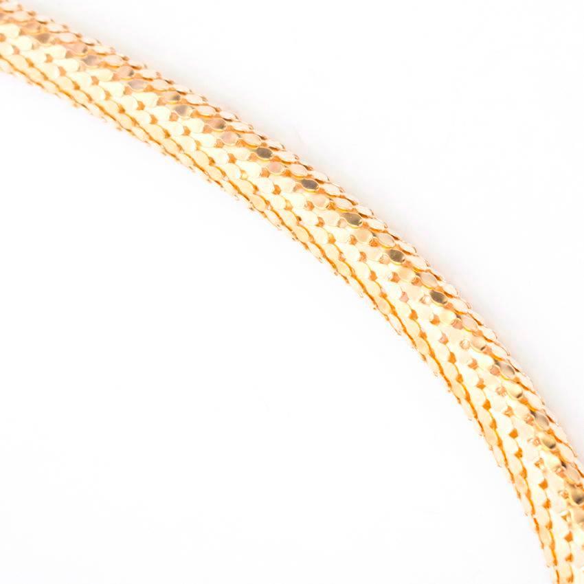 Alberta Ferretti gold scaled chain necklace with a twisted snake. Features diamante embellishments on the snake's head. The snake is not attacked to the necklace and can be moved along the chain. Fastens at the back with a lobster clasp. The item