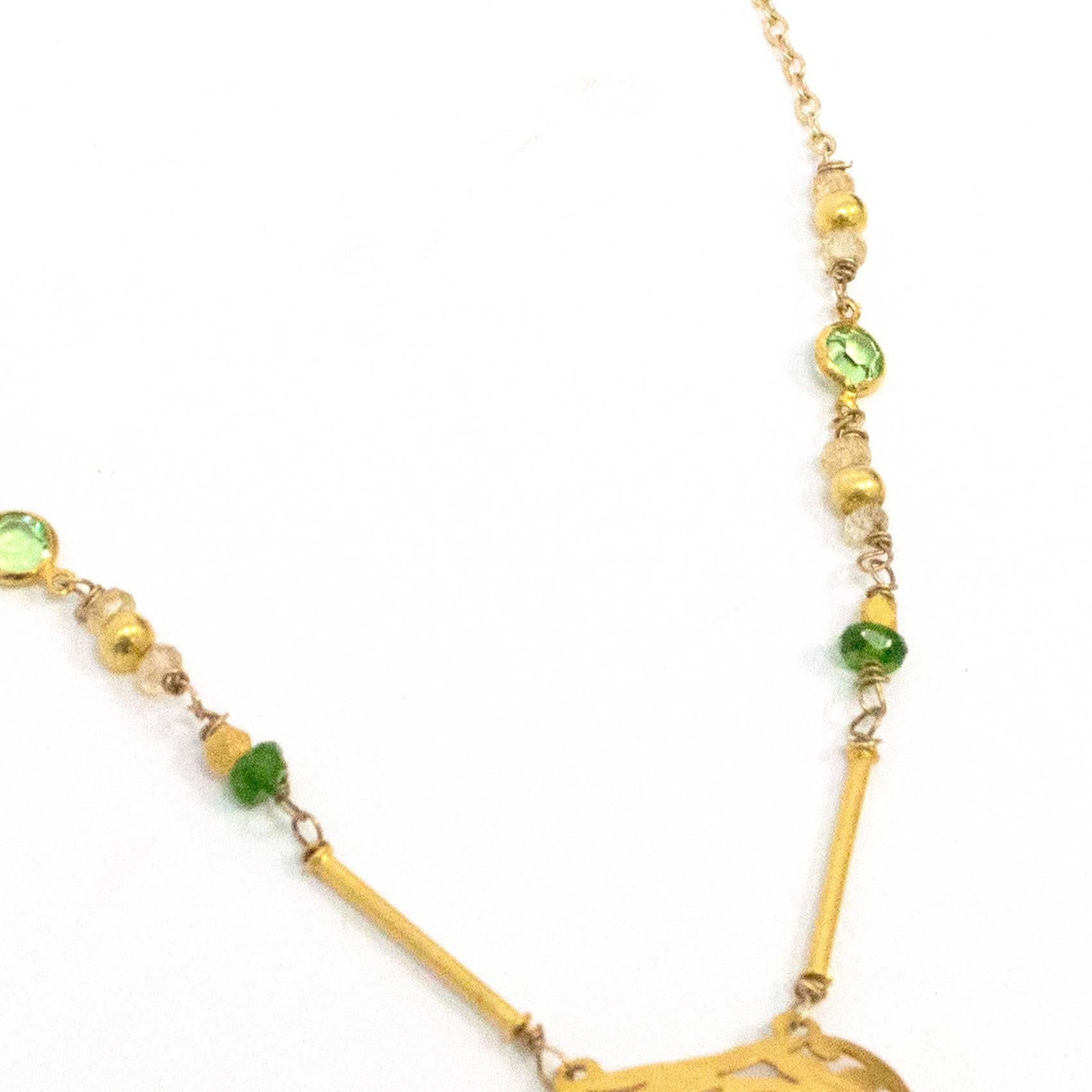 9ct gold  beaded necklace with matching earrings.

Delicate necklace with metal cut out detail and short thin chain with green bead and gem embellishment.

Hook earrings with gold cut out detailing  and green beads. Light weight.

Comes with box but