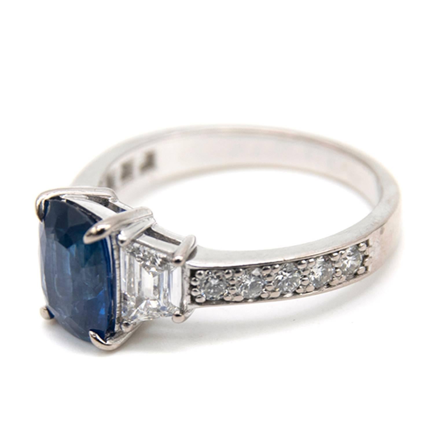 Sapphire and diamond set ring. Centrally set with a cushion shaped mixed cut medium blue sapphire, measuring approx. 9.27mm x 6.57mm, depth 4.36mm. Calculated carat weight 2.50 carat, moderate inclusions, some colour banding, surface facet wear and
