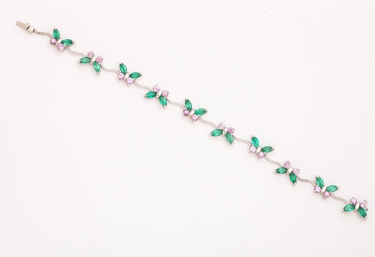 Set in 14 kt white gold, these emerald marquise (7.50cts) and pink sapphire (5.75 cts) butterflies will gracefully accent your wrist. A delightful color combination for a feminine yet substantial bracelet, are appropriate for any season. The clasp