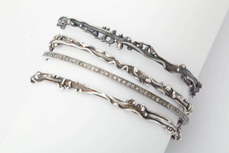 These 3 organic design silver bangles compliment the pave set silver and diamond bracelet. The 3 bangles sport different levels of oxidation, lighter and darker to increase texture and variety.  They can be worn alone as a set or in combination with