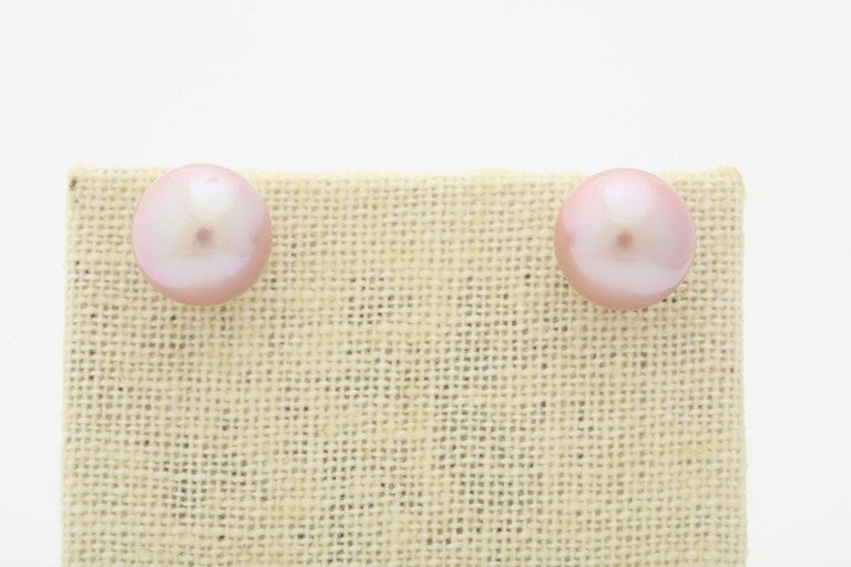 These are a wonderful pink color, completely round fresh water pearl studs. The pearls are 13 mm in diameter. The post and back are 14 kt gold. Thes earrings match necklace # j696150820830843fs- a multi colored pearls necklace, and
