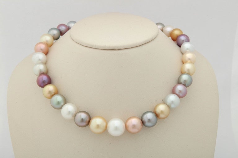 This superb pearl necklace is a combination of Tahitian, South Sea and fresh water pearls, all natural colors. The size range is from 15mm to 12mm in the back by the 18 kt clasp.  The length of the necklace is approximately 17 in.The combination of