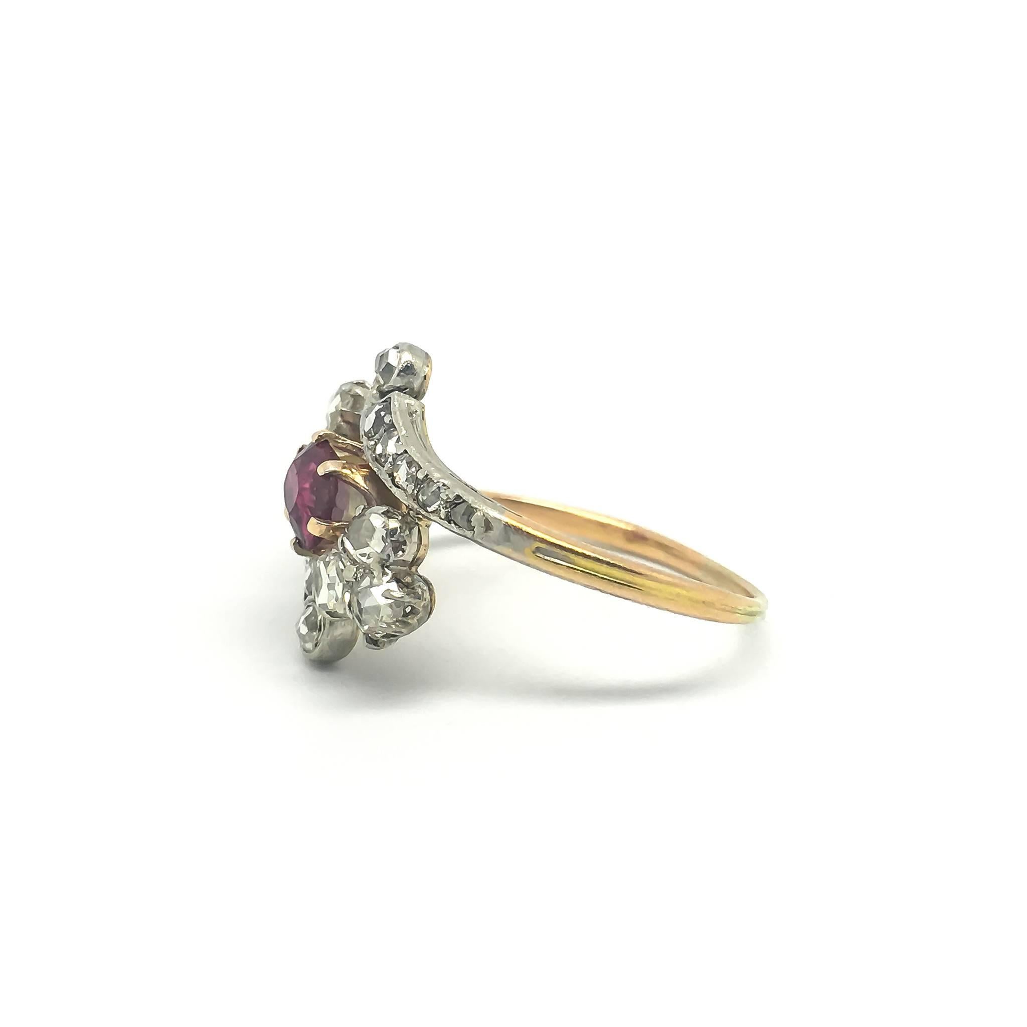 A stunning Edwardian Ruby and Diamond dress ring. 

The central ruby is flanked by two clusters of rose cut diamonds which are set between diamond studded scroll shoulders. 

UK size P 1/2
US size 7 3/4

Crafted from 18ct gold. 