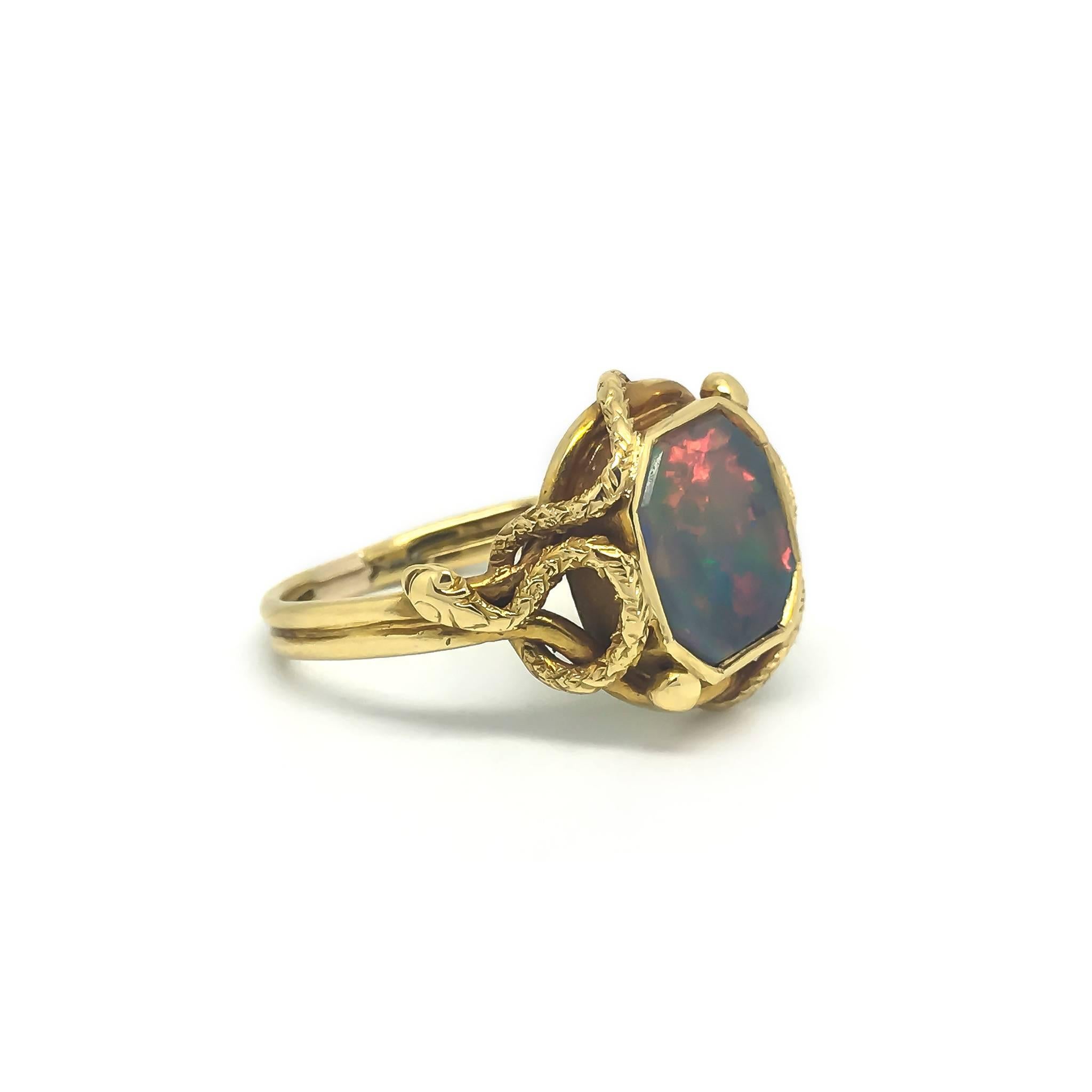 A stunning Victorian Snake ring set with an opal.

Two snakes adorn the shoulders of this beautiful piece. The opal displays a palette of pastel colours.

UK size P 1/2
US size 7 3/4

The Opal is a doublet and is believed to be a replacement. Opal