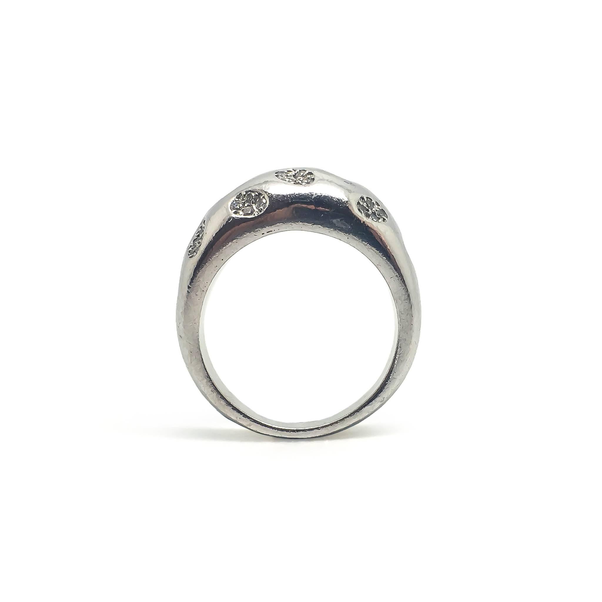 A heavy platinum and diamond ring by Farone.

The ring weighs 15.4g. 

UK size R 1/2

US size 8 7/8

The ring is crafted from platinum and set with diamonds across the surface.

Signed Farone inside with a 950 mark for Platinum.