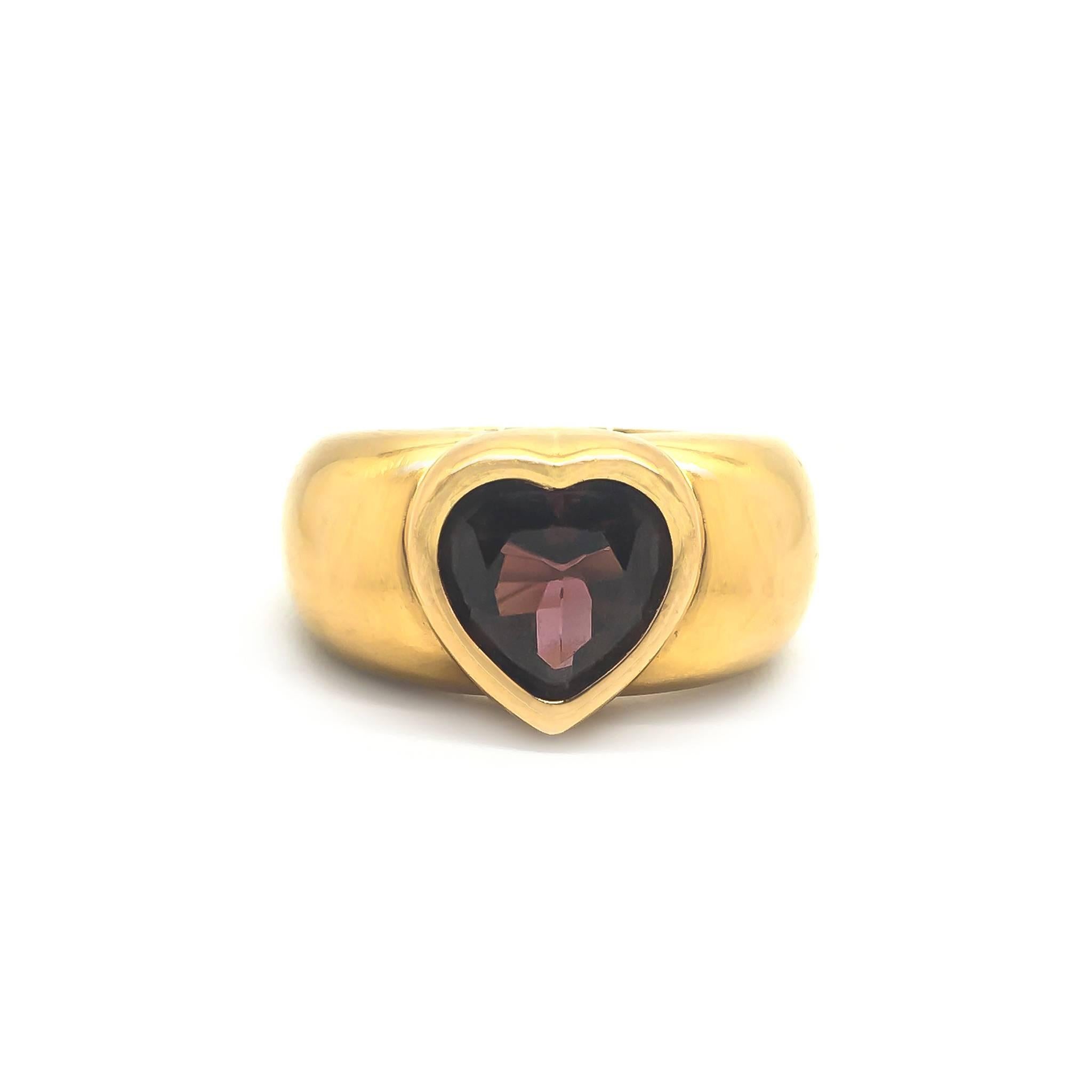 A heart ring by Piaget. 

Set with a Pyrope Garnet. 

UK size O 1/2

US size 7 1/4

19.3g
