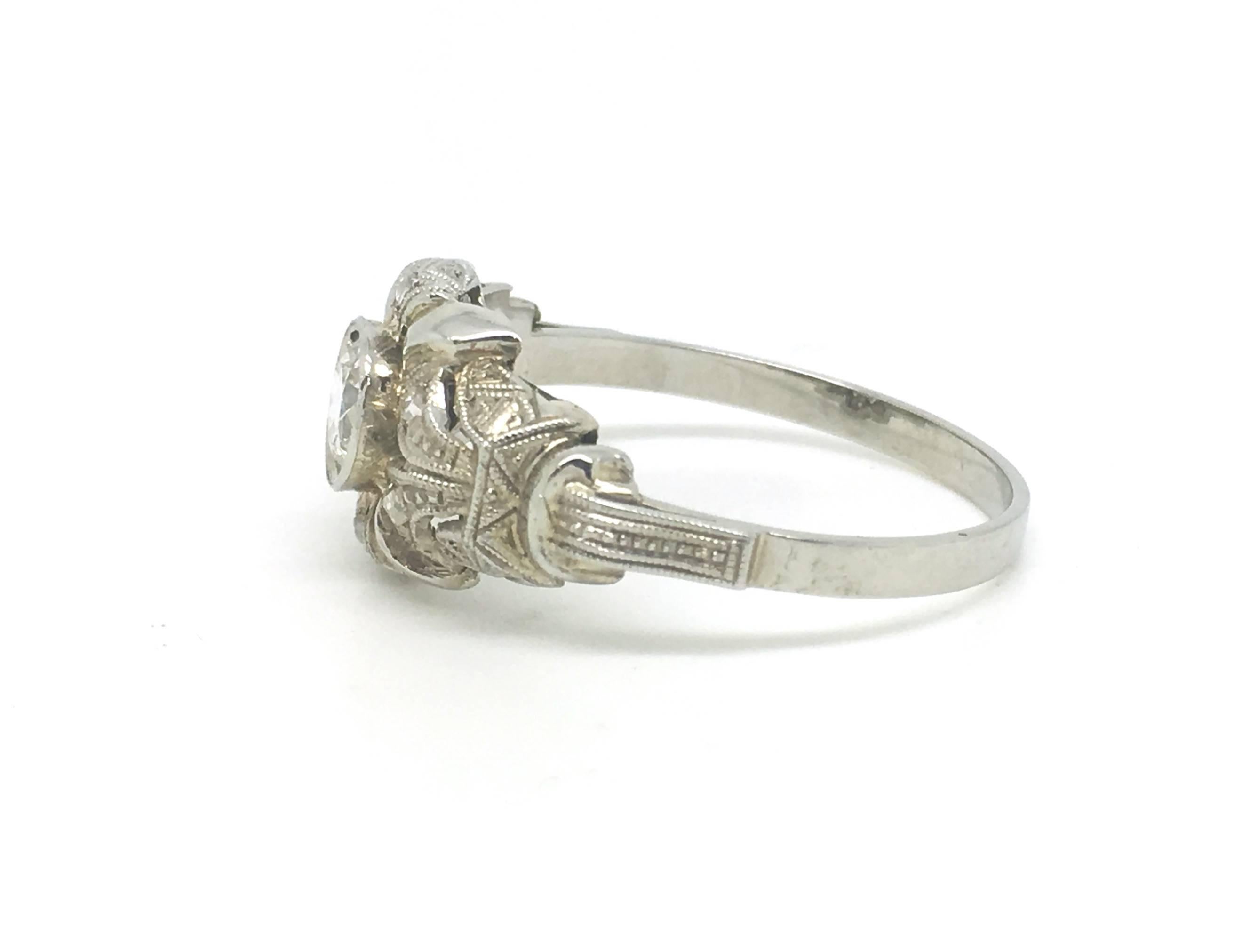 A lovely ring in the Art Deco style but dating to the latter half of the 20th century.

The centre stone is approximately 0.33cts and is estimated to be VS2/SI and H colour.

Rose cut details around the ring.

UK size Q

US size 8

2.1g

The face of