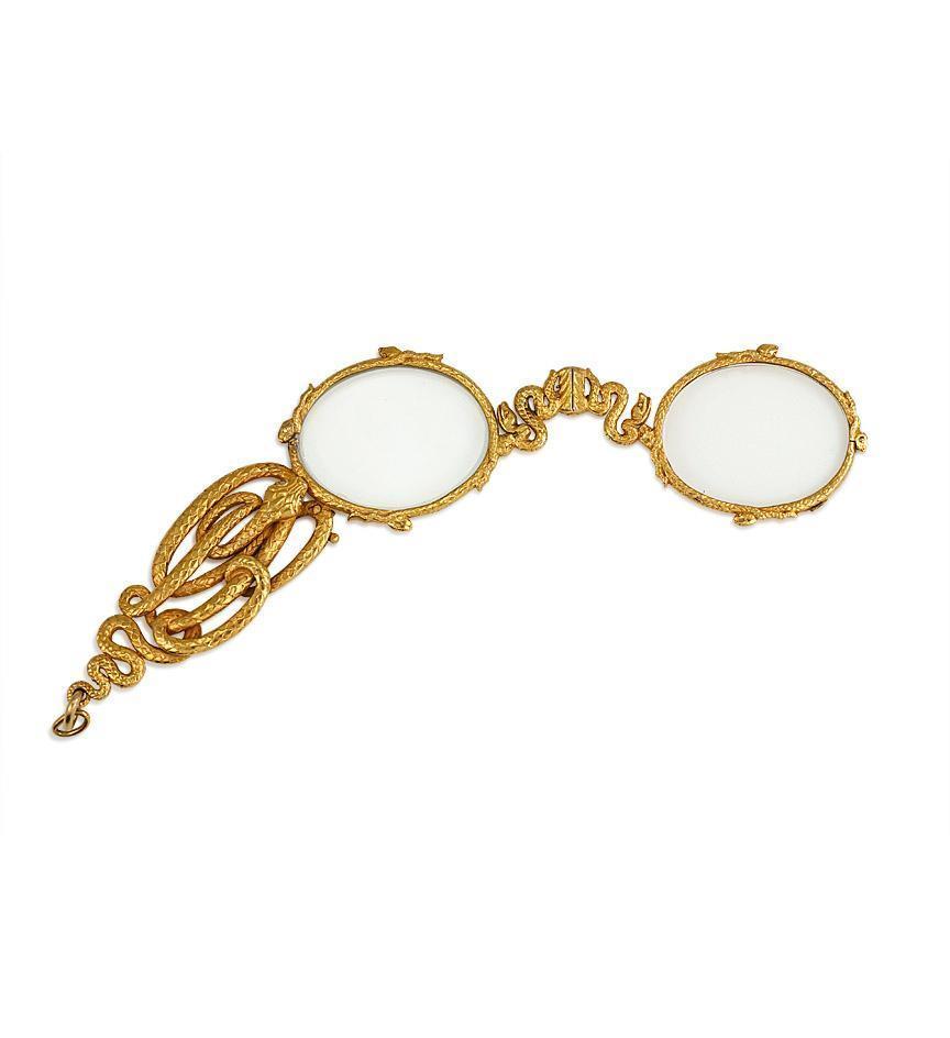 An antique gold lorgnette with decoration comprised of entwined serpents with cross hatched engraving, in 18k. Tiffany & Co. In custom-fitted box.