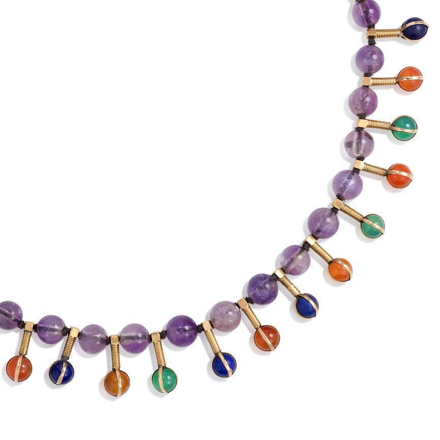 An antique gold fringe necklace comprised of amethyst beads intersected with carnelian, lapis and chrysophrase bead pendants, in 18k.  France.