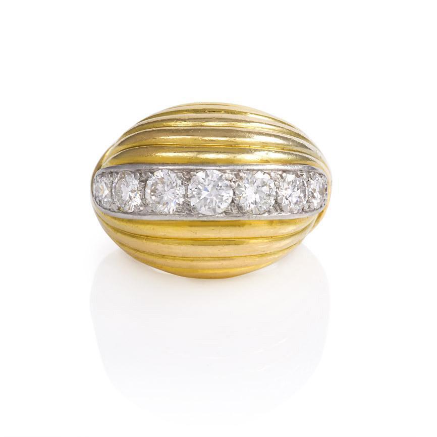 A Retro gold ring of ribbed bombé design with a central horizontal panel of diamonds, in 18k. Cartier, Paris.  Top measures approximately 15mm from top to bottom.