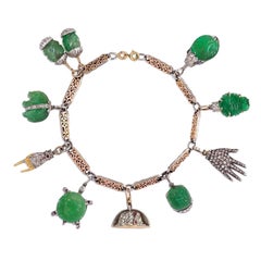 French Art Deco Carved Emerald and Diamond Charm Bracelet in Gold and Platinum