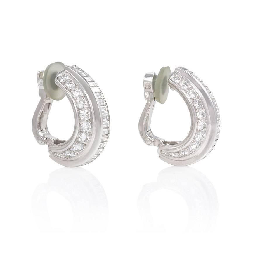 A pair of half-hoop diamond earrings set with baguette and round brilliant cut diamonds, in platinum and 18k white gold. Cartier, Paris, #927547.  Atw 4.60 cts.