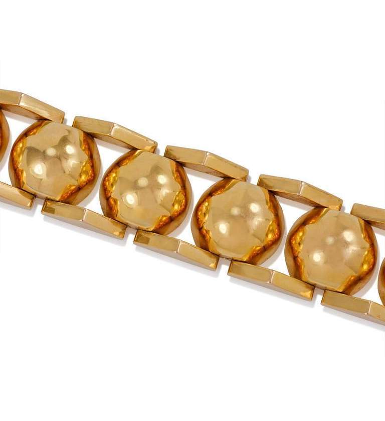 A Retro gold bracelet designed as a central row of half-dome links flanked by pyramidal motifs, in 18k. France.