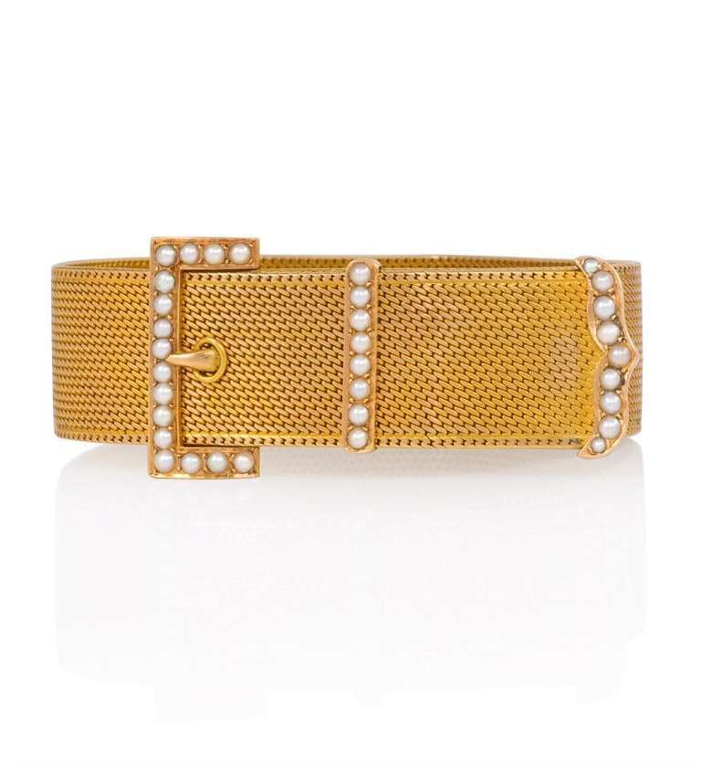 An antique woven gold adjustable jarretière bracelet with a pearl-set buckle motif, in 18k.  French import.