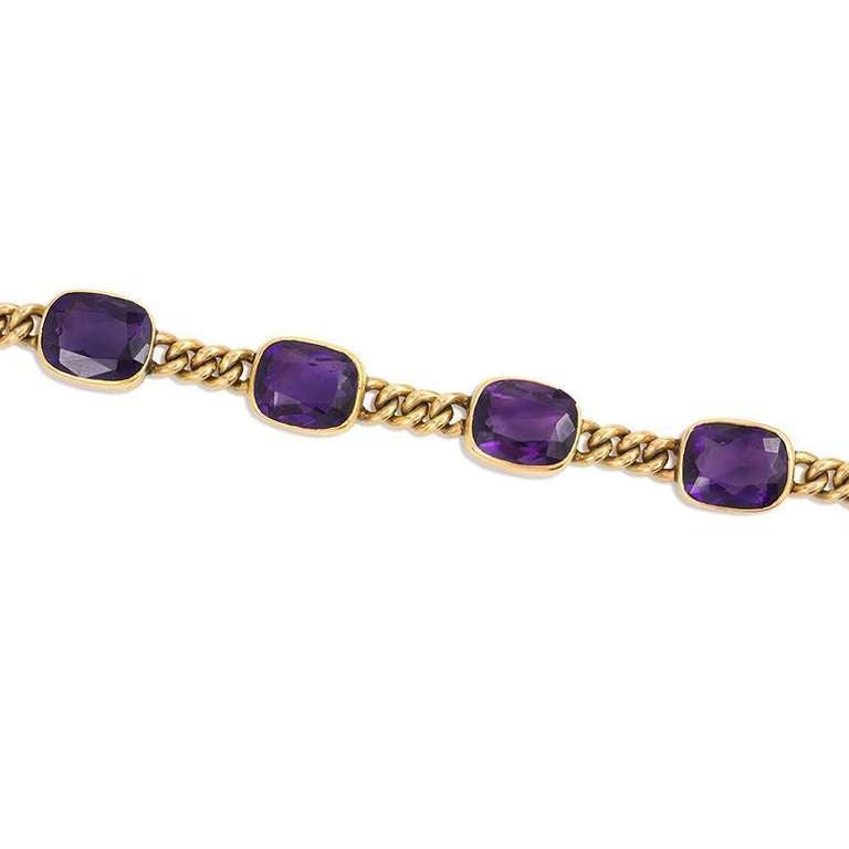 An antique gold bracelet of alternating curblink chain sections and collet-set cushion cut amethysts, in 14k.