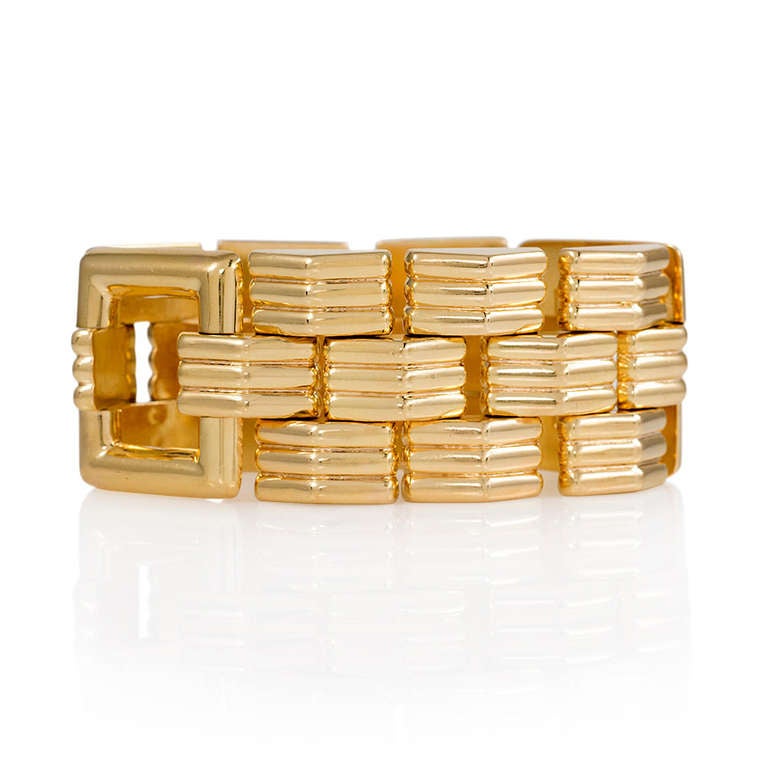A Retro gold tank bracelet of ribbed links with two square gold spacers, in 14k.