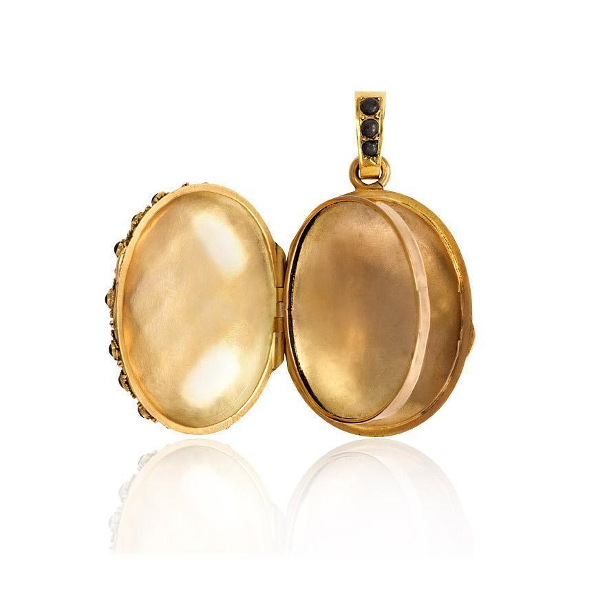 An antique gold locket pendant with pavé steel beads, in 18k.  French import marks.